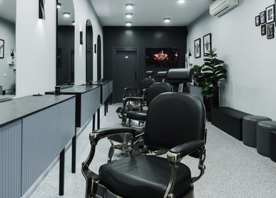 Chic interior of Homme Grooming, Naremburn, New South Wales, AU showcasing modern design and luxury barber chairs.