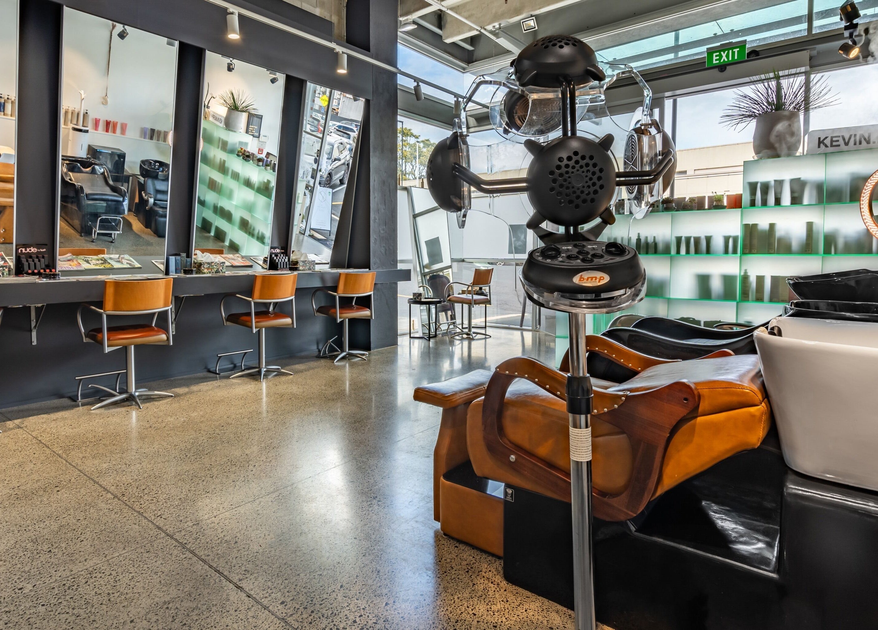 Chic interior of The Colour Bar salon in Auckland, NZ featuring modern styling stations and sleek design.