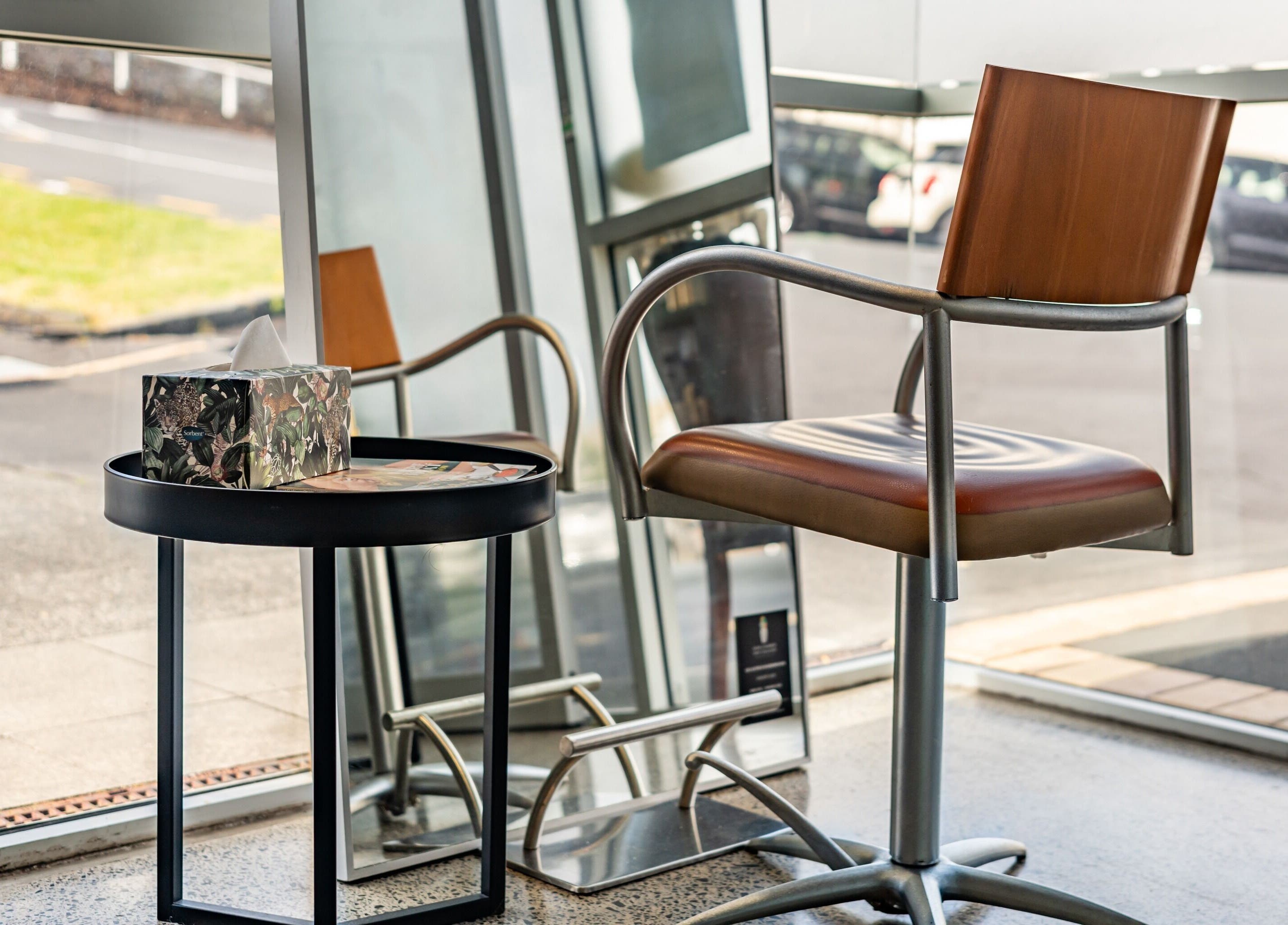 Modern salon chair by a window at The Colour Bar, Auckland, Auckland, NZ, inviting ambiance for clients.