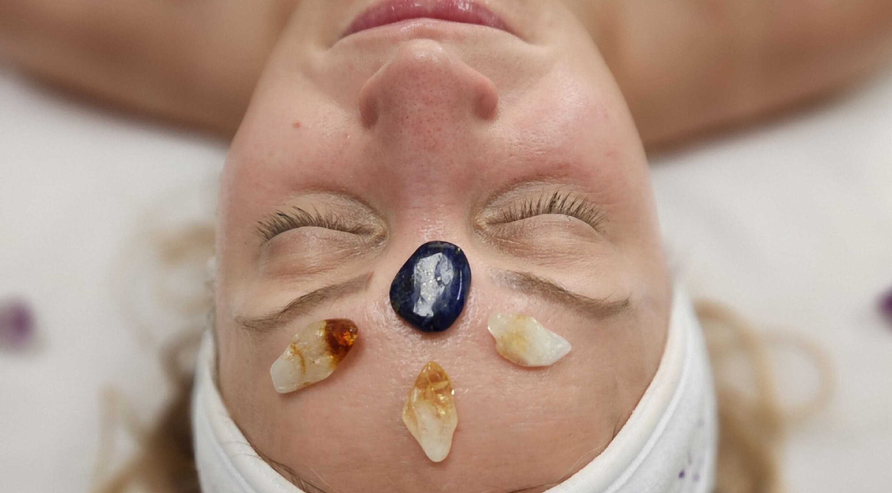 Facial with healing crystals at Enlightened Esthetics, Woodstock, Georgia, US promotes relaxation and wellness.