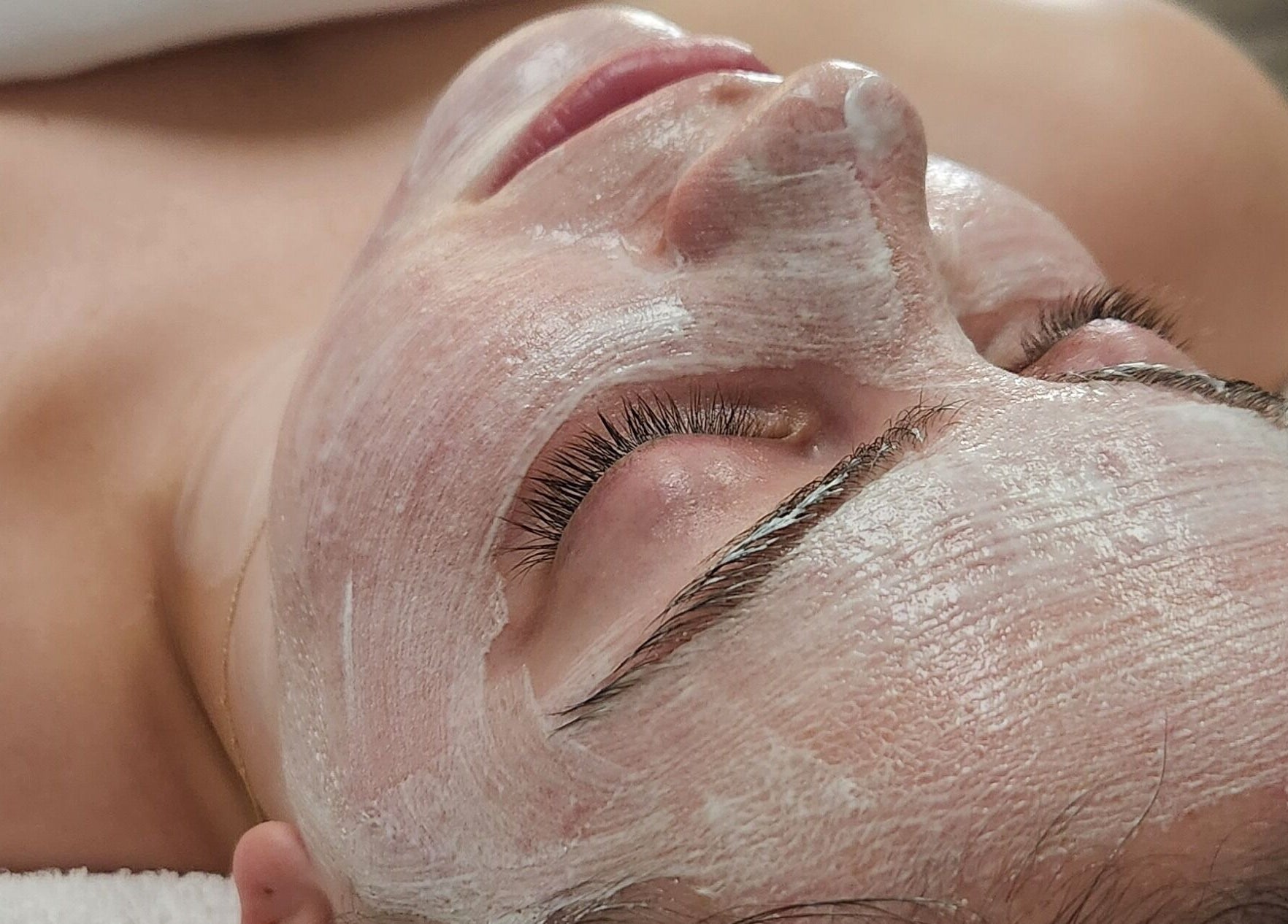 Facial mask treatment at Enlightened Esthetics, Woodstock, Georgia, US, showcasing relaxed and serene skincare.