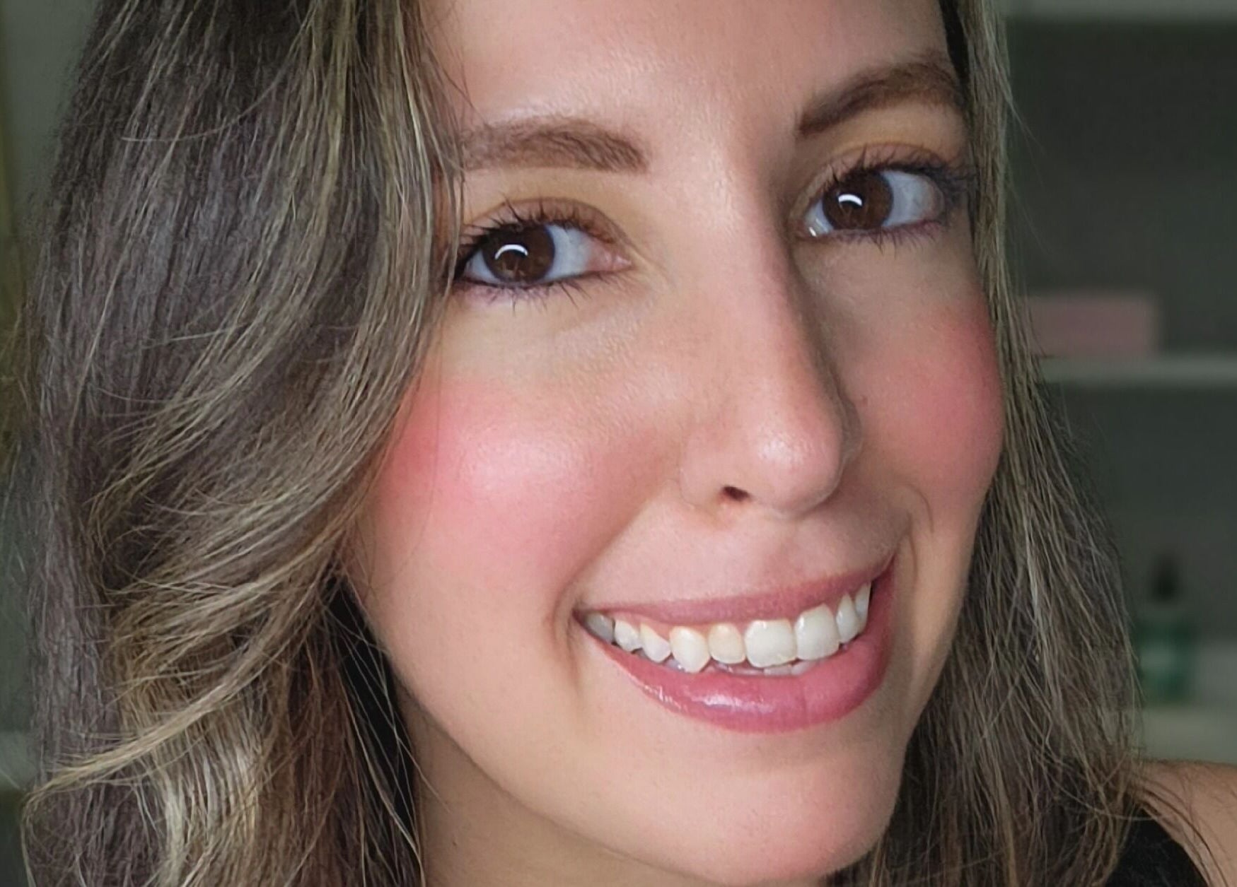 Smiling woman with healthy skin at Enlightened Esthetics, Woodstock, Georgia, US.