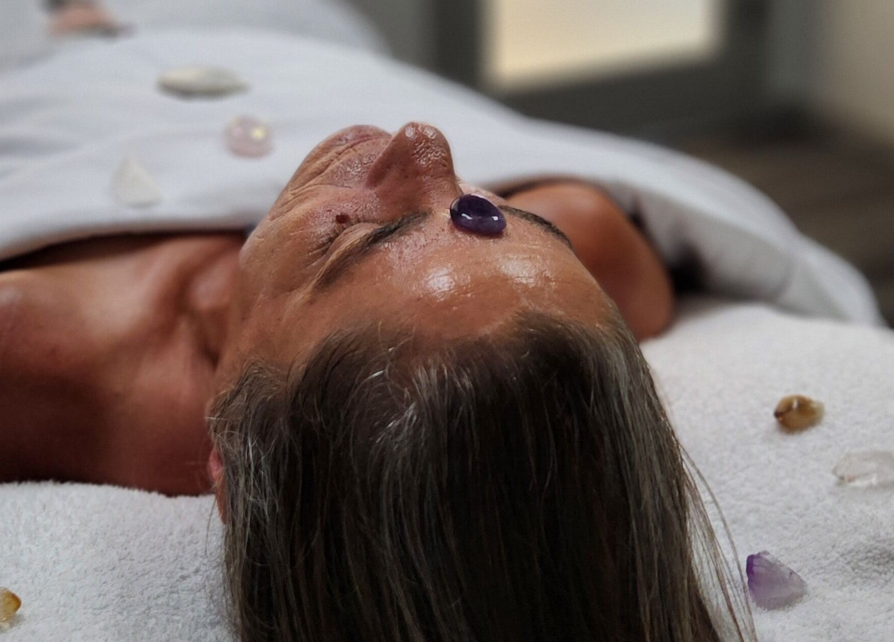 Relaxing crystal therapy session at Enlightened Esthetics, Woodstock, Georgia, US. Experience holistic rejuvenation.
