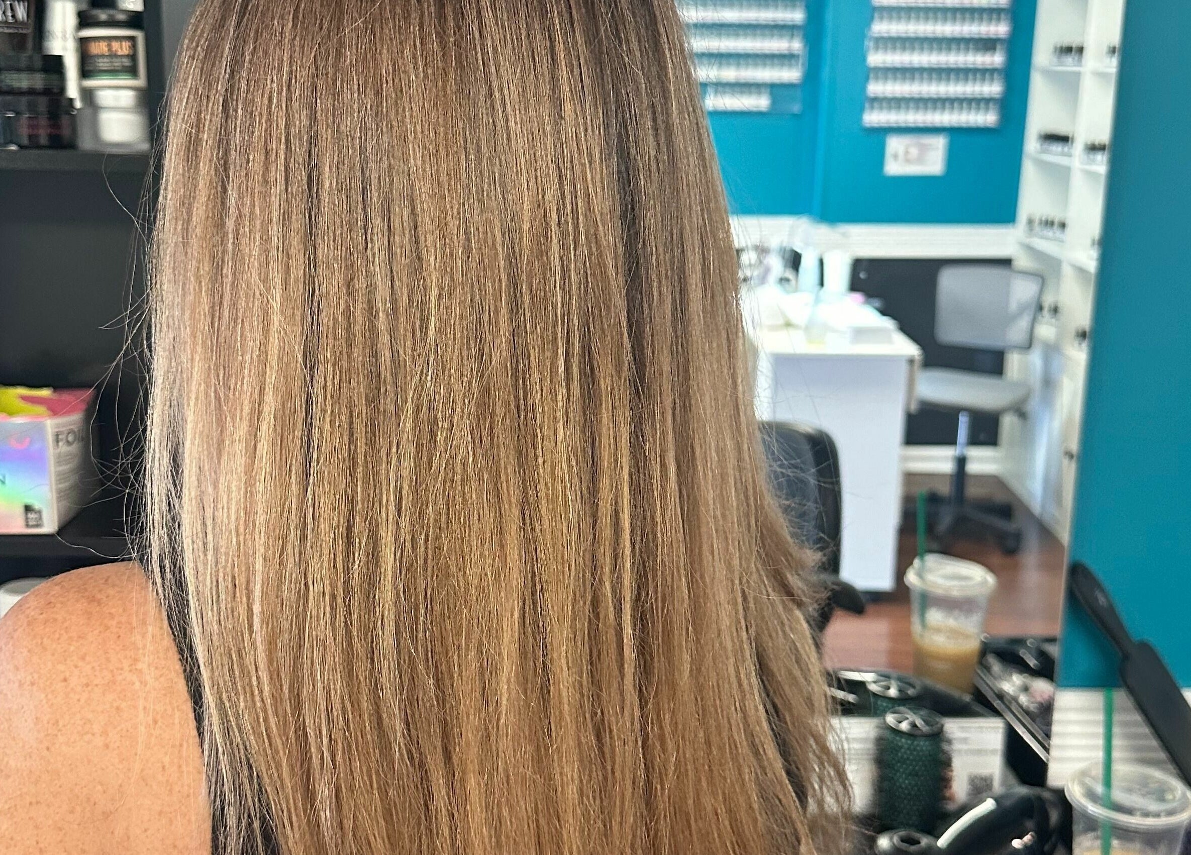 Smooth, straightened hair at Glitteratti Salón Florida in Ormond Beach, Florida, US. Modern salon interior visible.