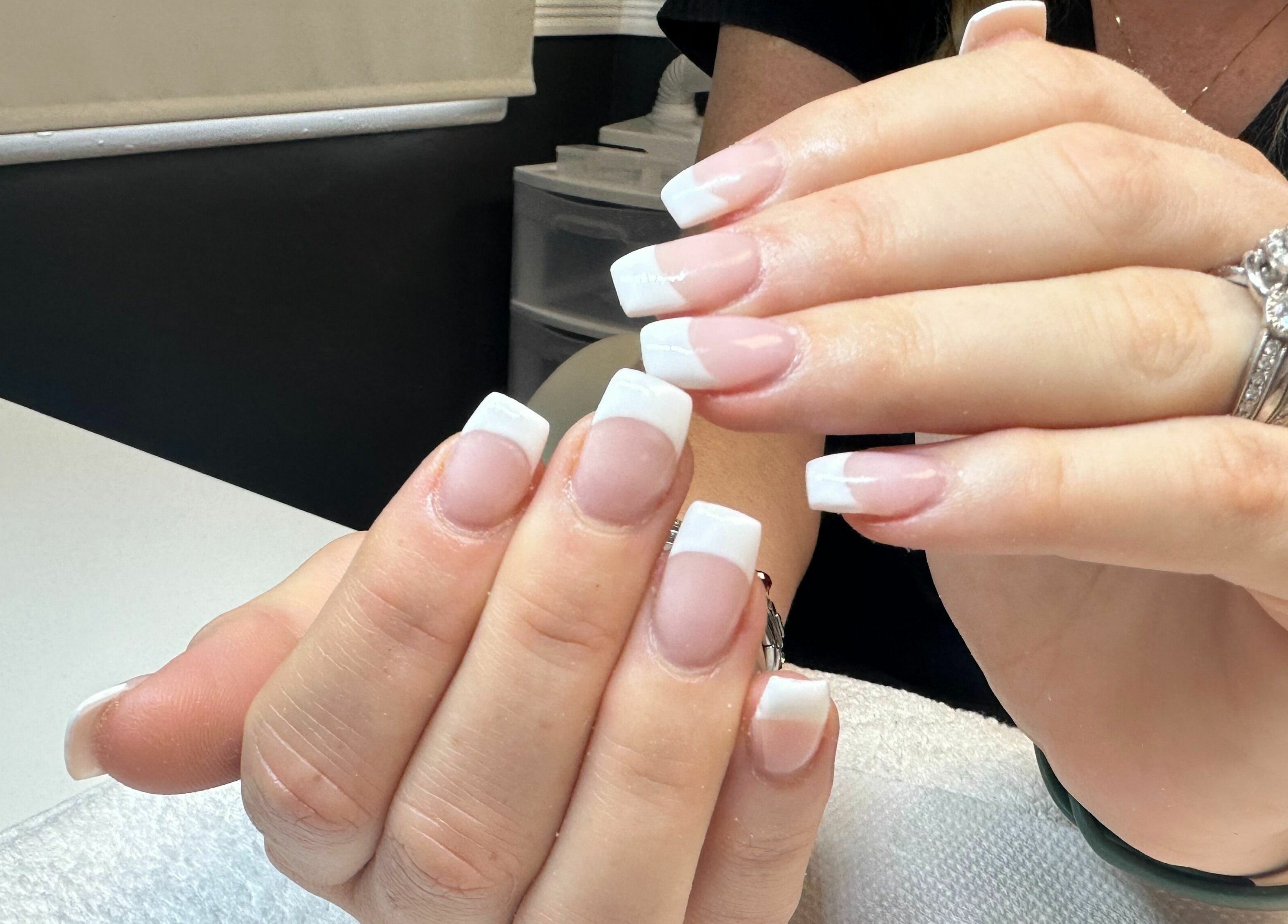 Elegant French manicure at Glitteratti Salón Florida in Ormond Beach, Florida, US, showcasing polished nails.