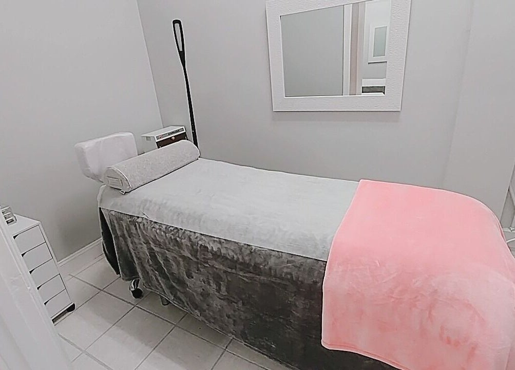 Relaxing treatment room at iBeauty Studio, Raleigh, North Carolina, US with cozy bed and modern decor.