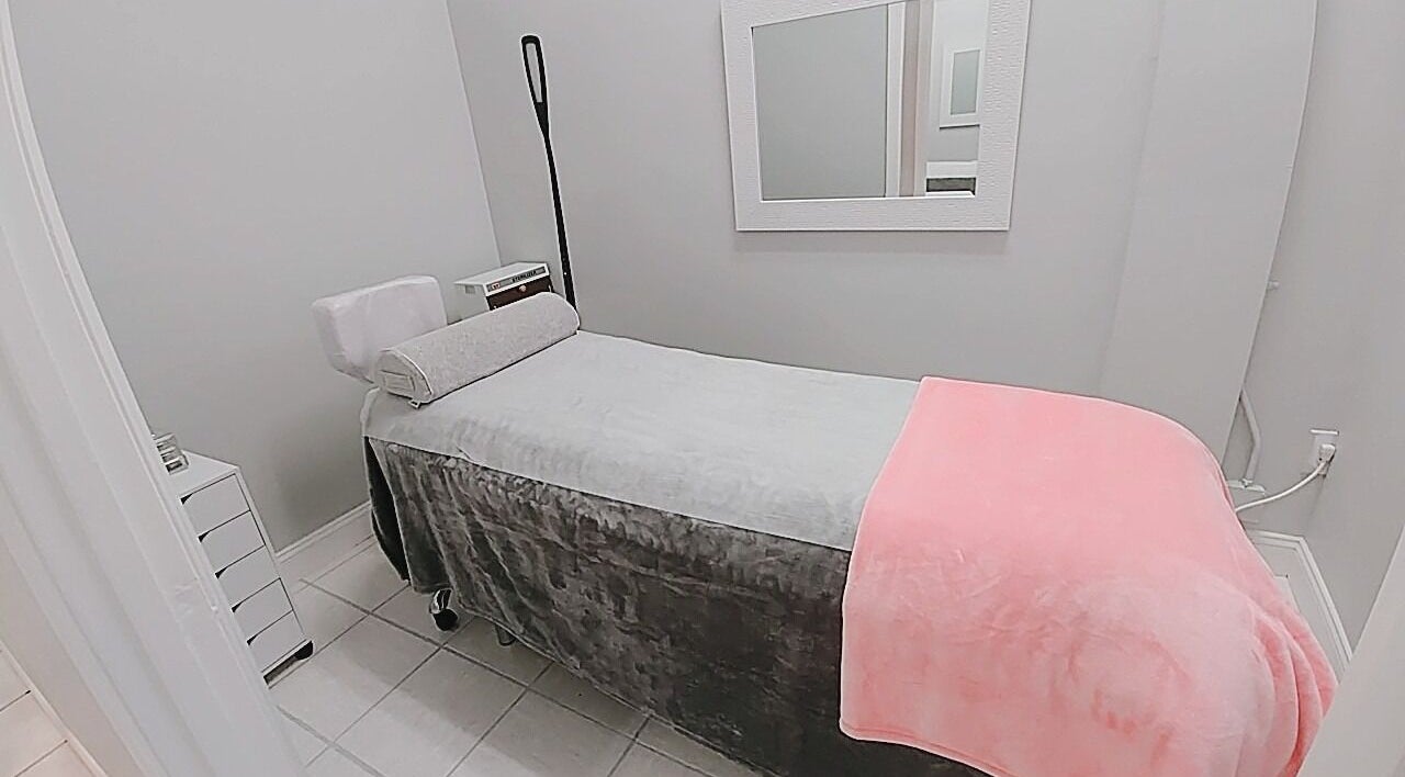 Relaxing treatment room at iBeauty Studio, Raleigh, North Carolina, US with cozy bed and modern decor.