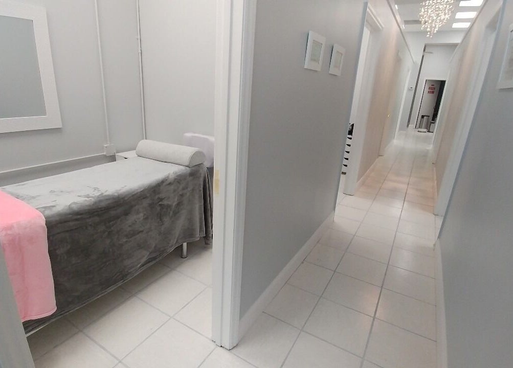 Serene treatment room at iBeauty Studio in Raleigh, North Carolina, US, featuring a cozy massage bed.