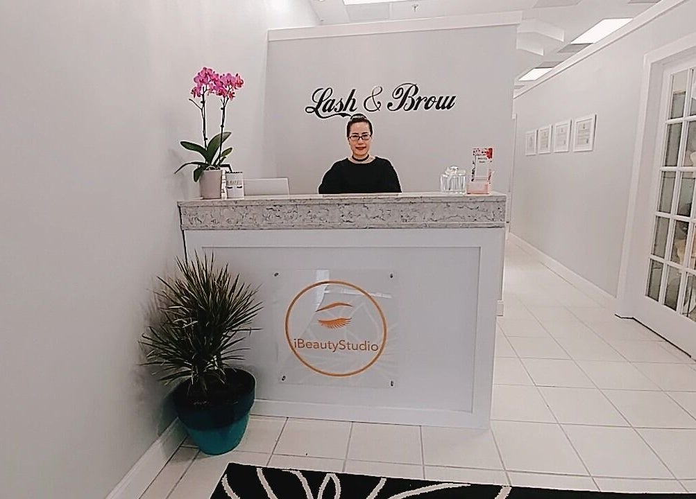 Reception area of iBeauty Studio in Raleigh, North Carolina, US with elegant decor and signage.