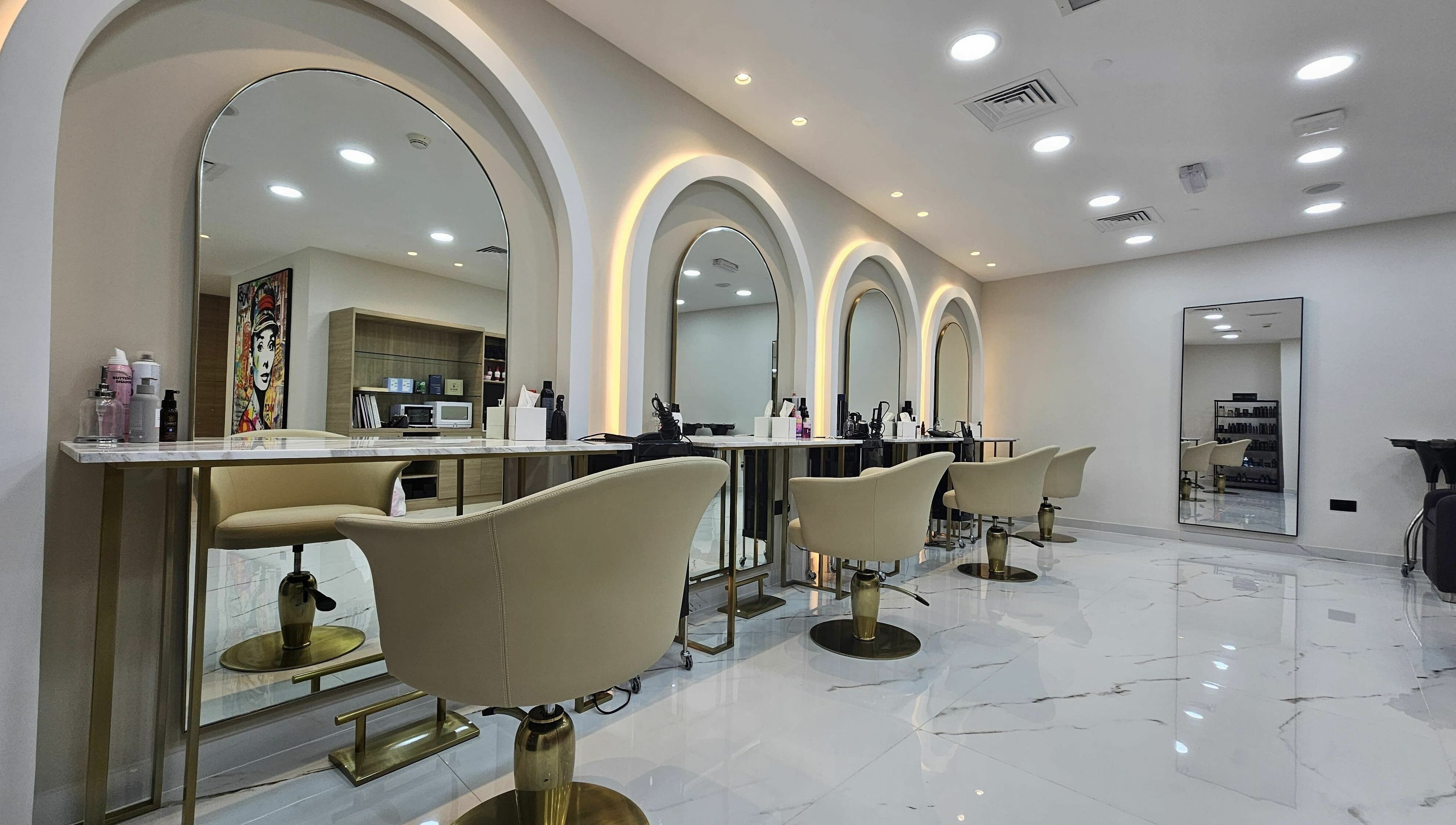 Modern salon interior at Barbella by Blue Tree, Dubai, Dubai, AE, featuring sleek styling stations and elegant chairs.
