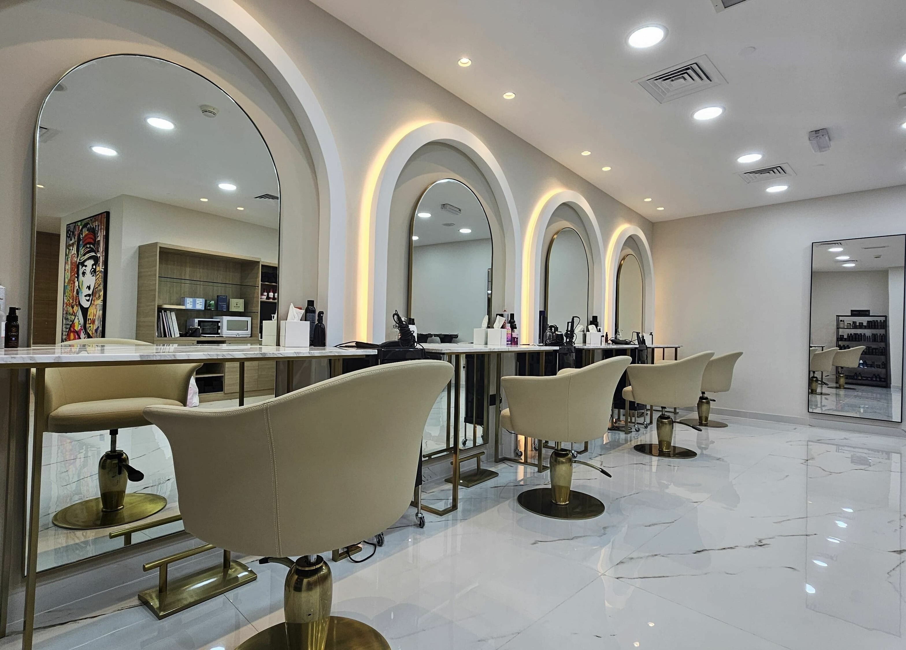 Modern salon interior at Barbella by Blue Tree, Dubai, Dubai, AE, featuring sleek styling stations and elegant chairs.