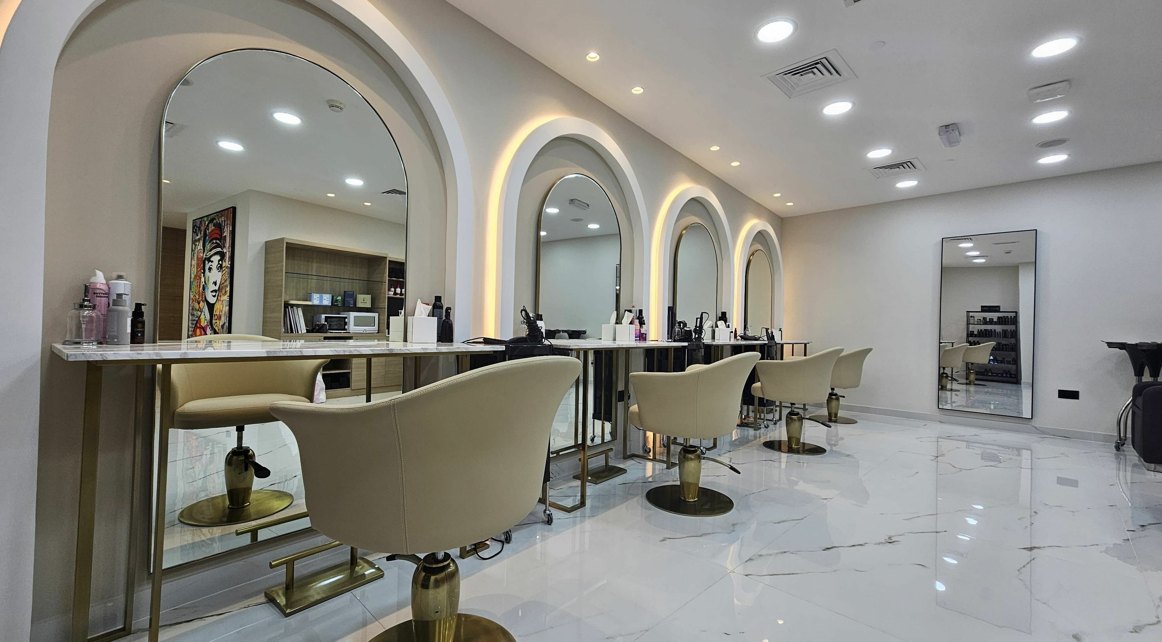 Modern salon interior at Barbella by Blue Tree, Dubai, Dubai, AE, featuring sleek styling stations and elegant chairs.