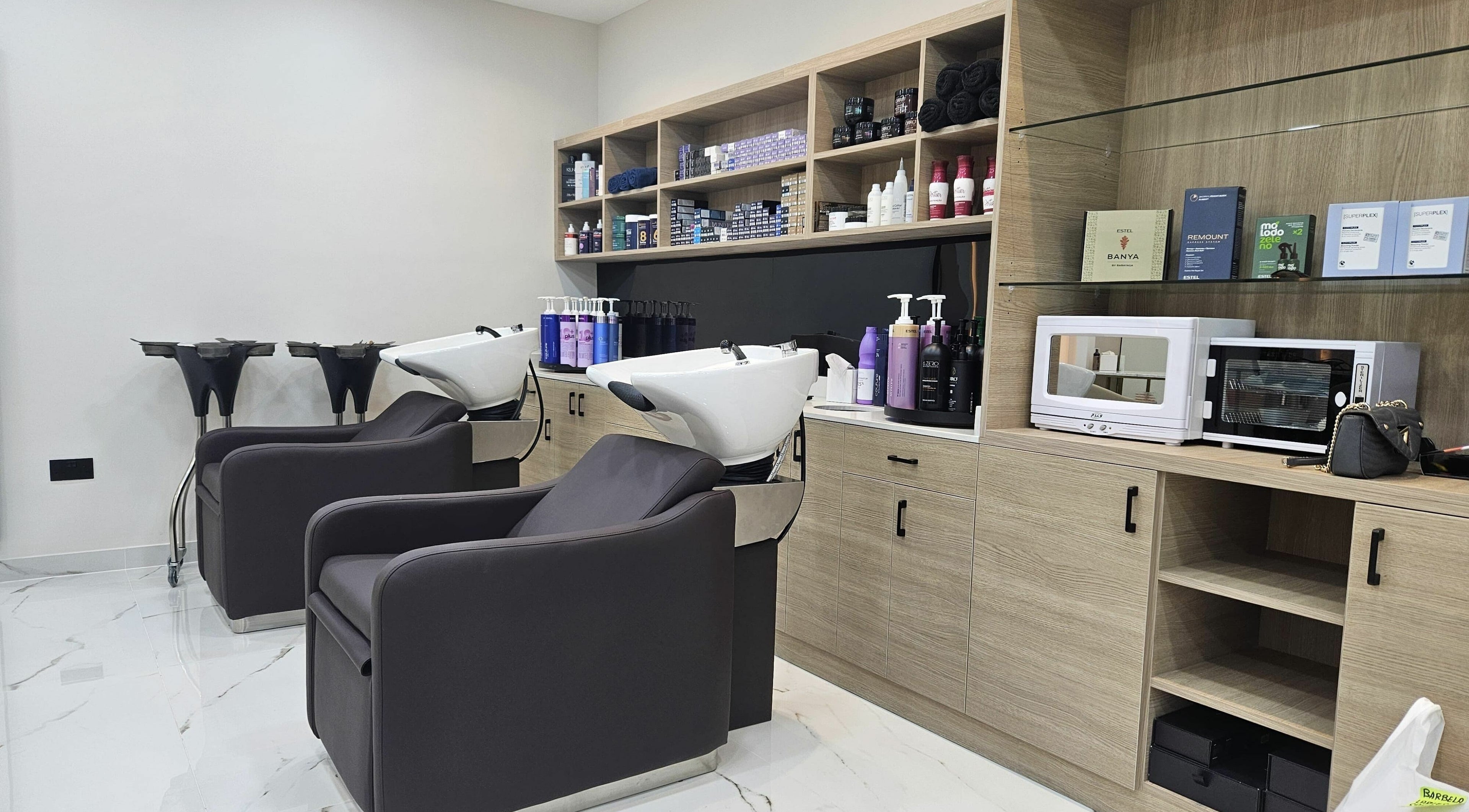Elegant salon wash area at Barbella by Blue Tree in Dubai, Dubai, AE with modern equipment and products.