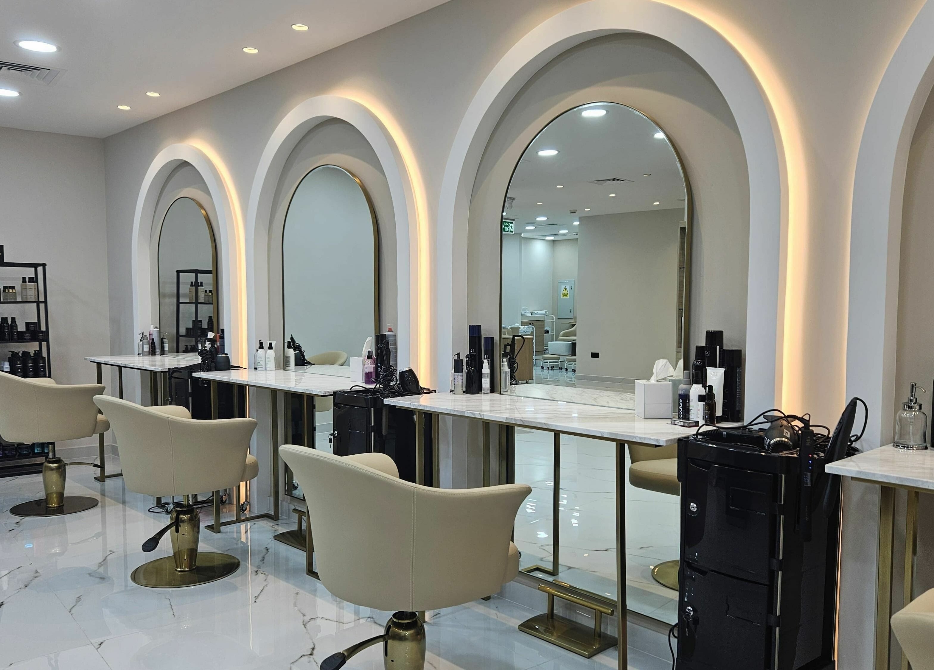 Elegant salon interior at Barbella by Blue Tree, Dubai, Dubai, AE with stylish chairs and mirrors.