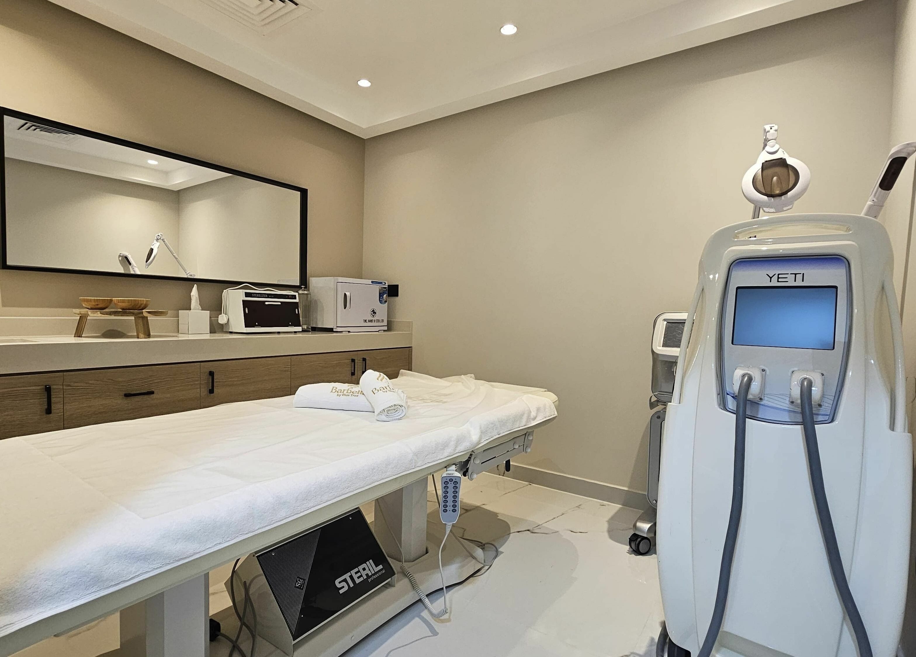 Relaxing treatment room at Barbella by Blue Tree in Dubai, Dubai, AE showcasing a massage table and Yeti machine.