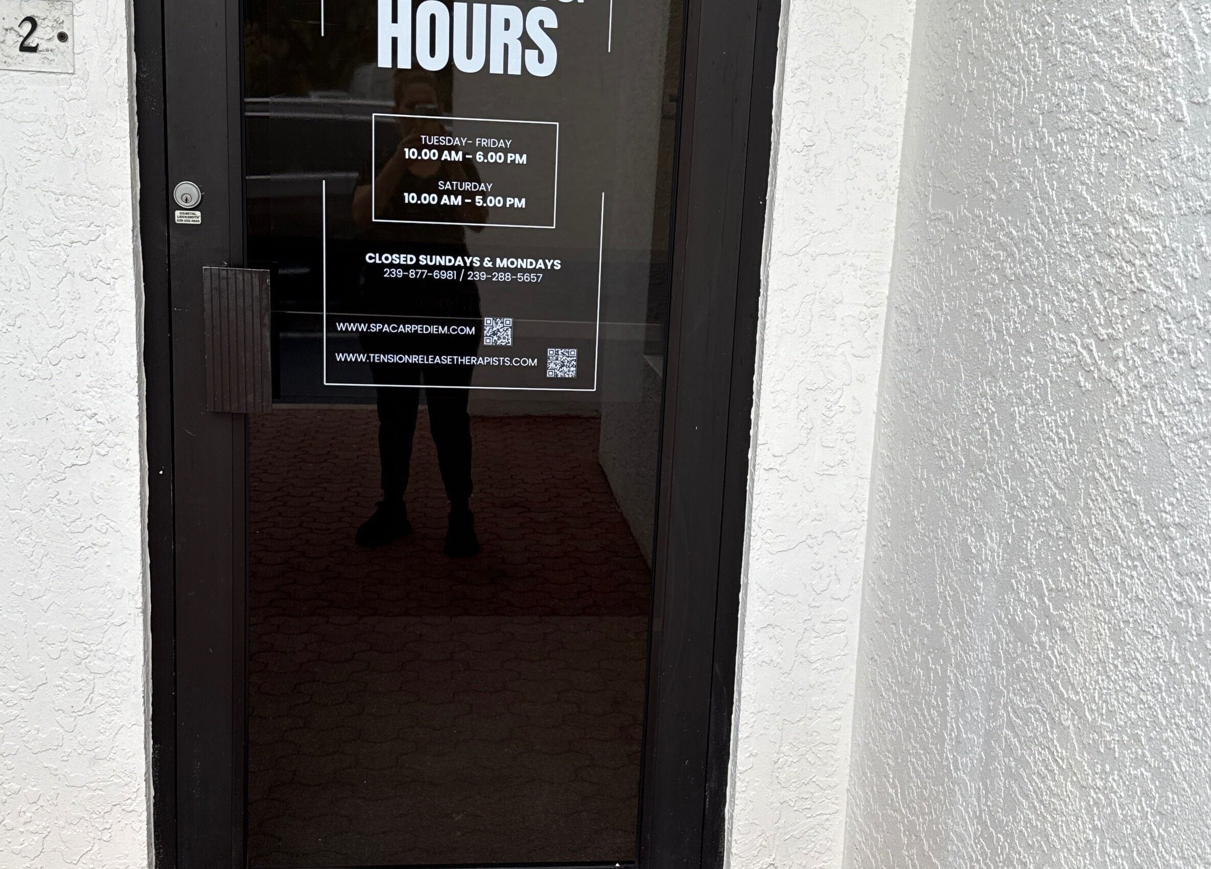 Entrance to Tension Release Therapy - Massage in Fort Myers, FL, showcasing operating hours.