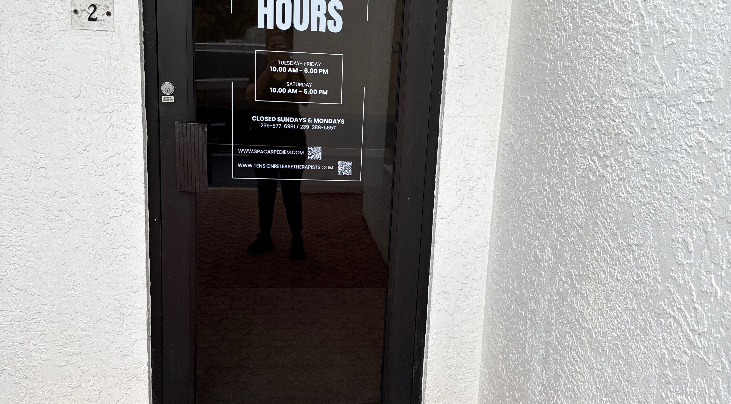 Entrance to Tension Release Therapy - Massage in Fort Myers, FL, showcasing operating hours.