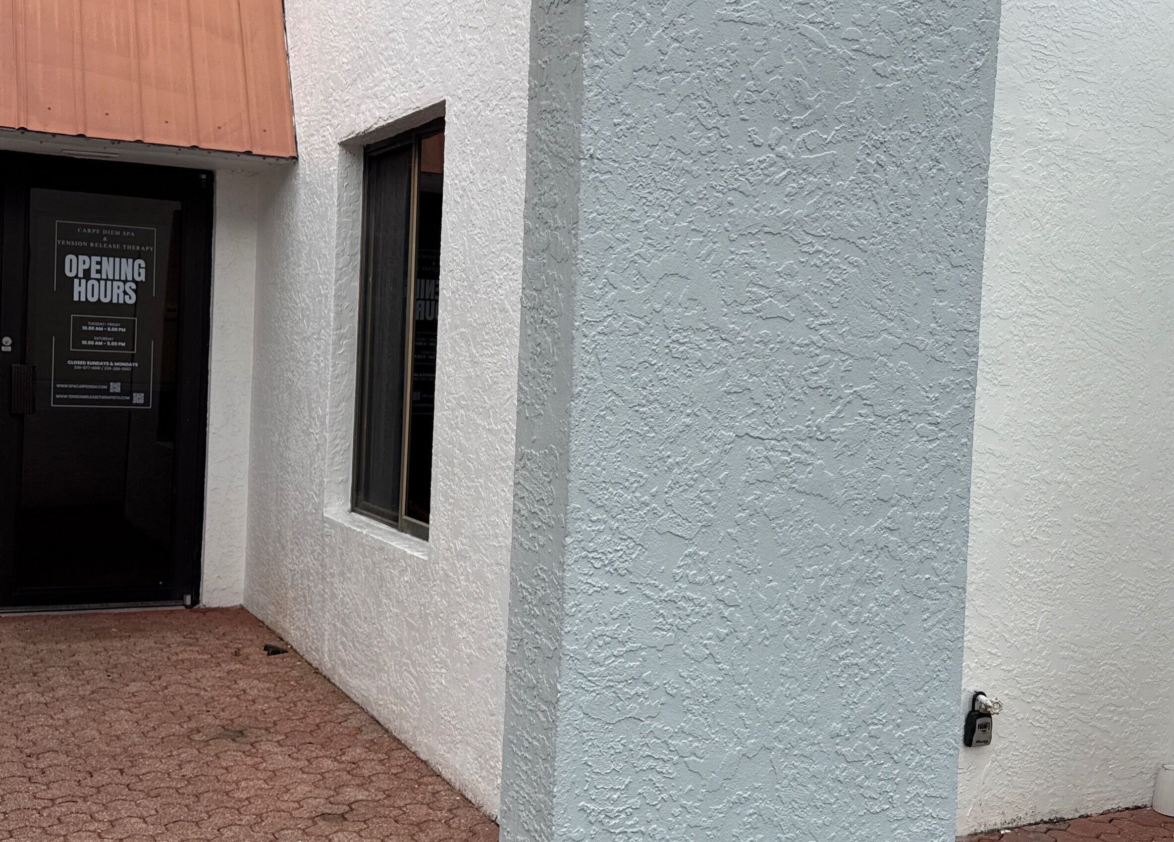 Entrance of Tension Release Therapy – Massage in Fort Myers, FL, showcasing door with opening hours.