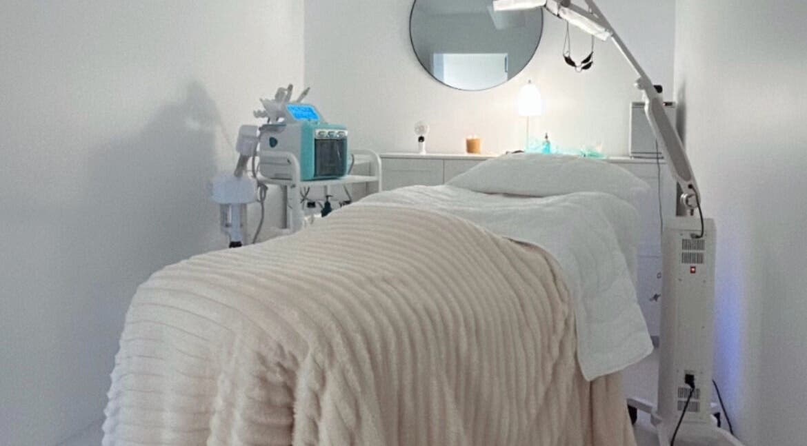 Serene spa room at Derma Corner, Parramatta, New South Wales, AU, featuring cozy treatment bed and elegant decor.