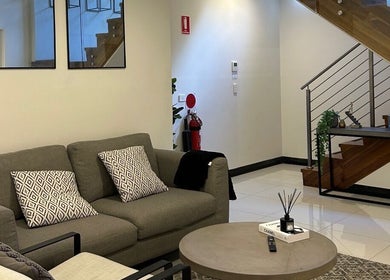 Stylish lounge area with modern decor at Derma Corner, Parramatta, New South Wales, AU.