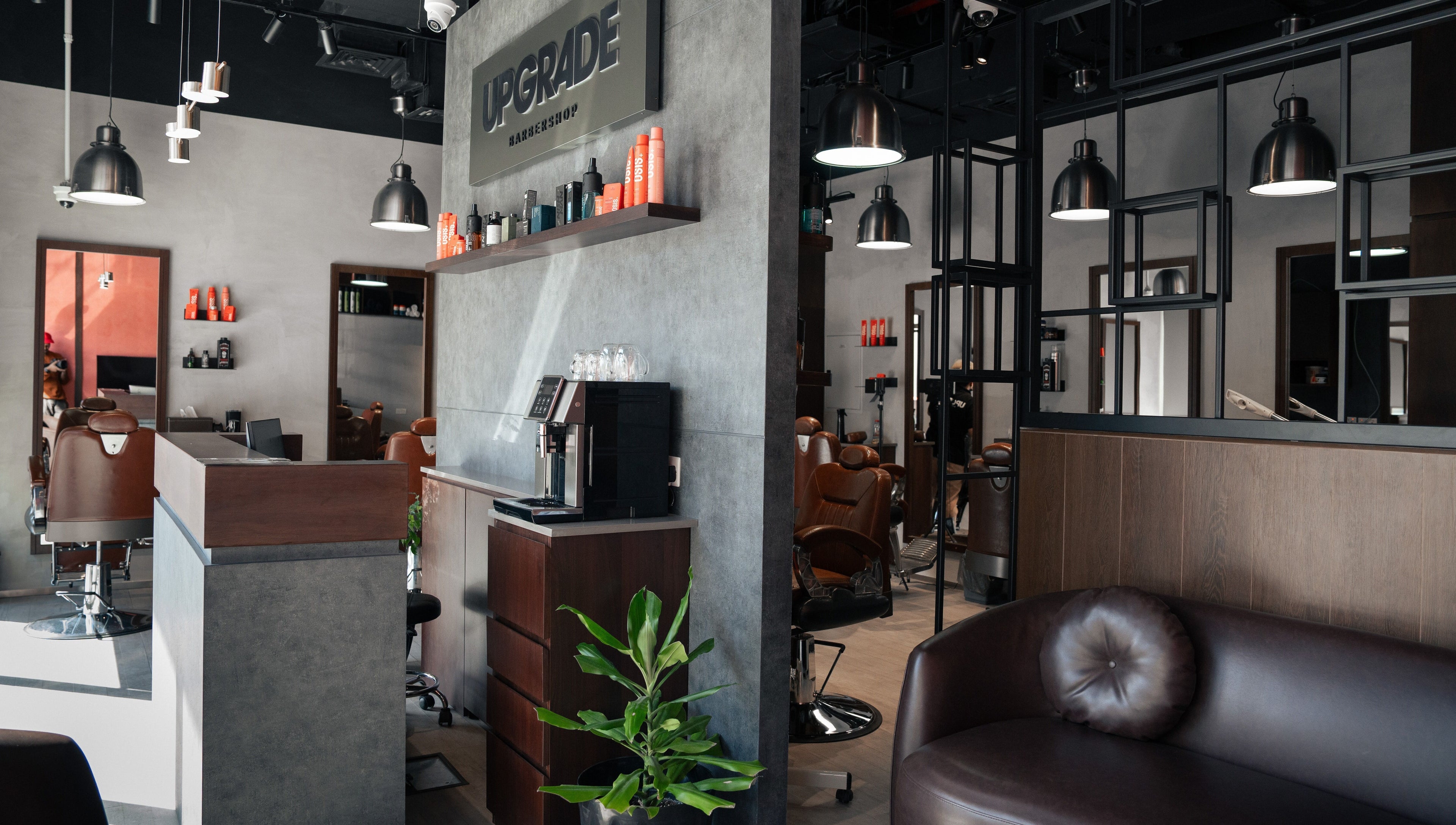 Interior of Upgrade Barbershop JVC in دبي, دبي, AE, featuring stylish chairs and modern decor.