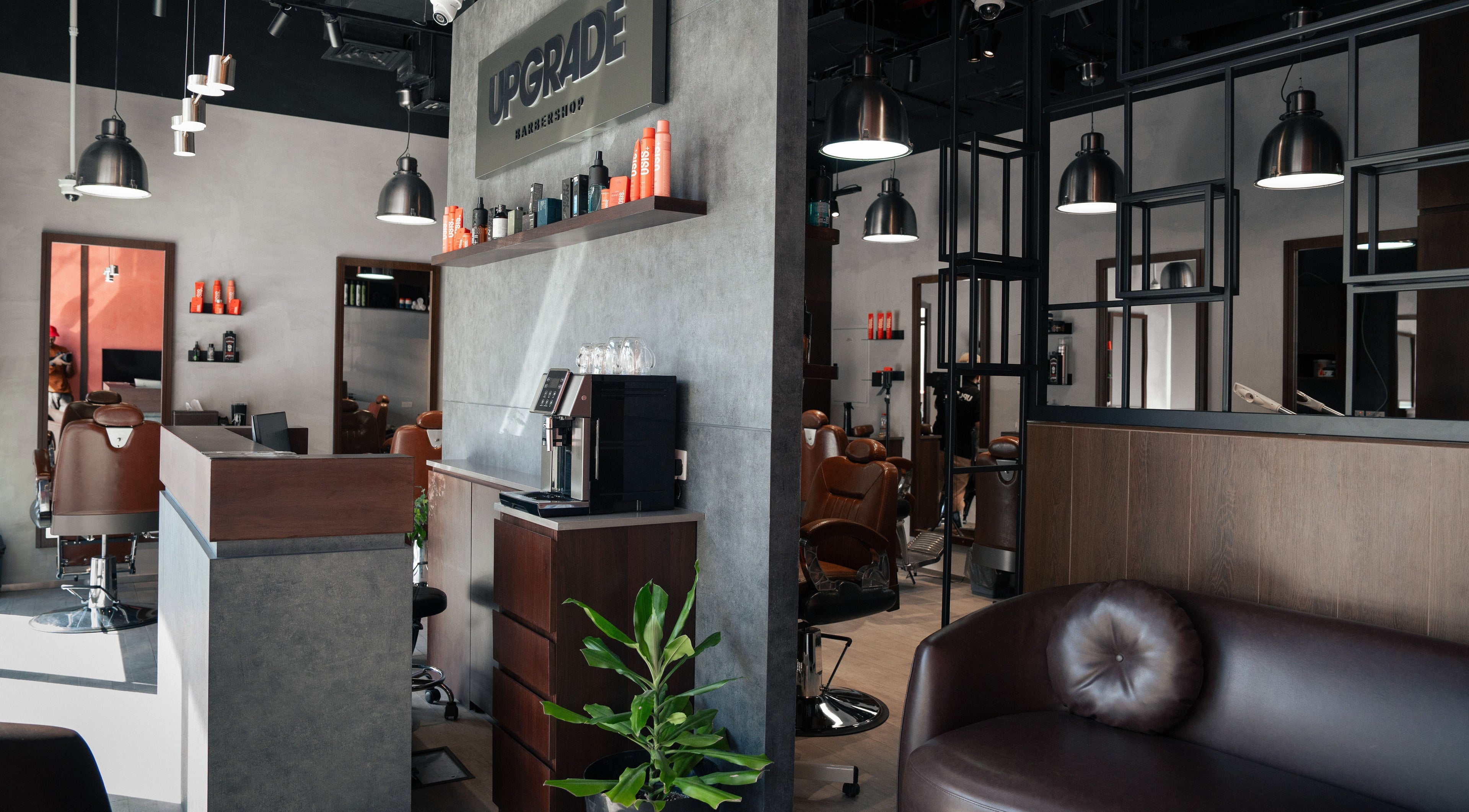 Interior of Upgrade Barbershop JVC in دبي, دبي, AE, featuring stylish chairs and modern decor.