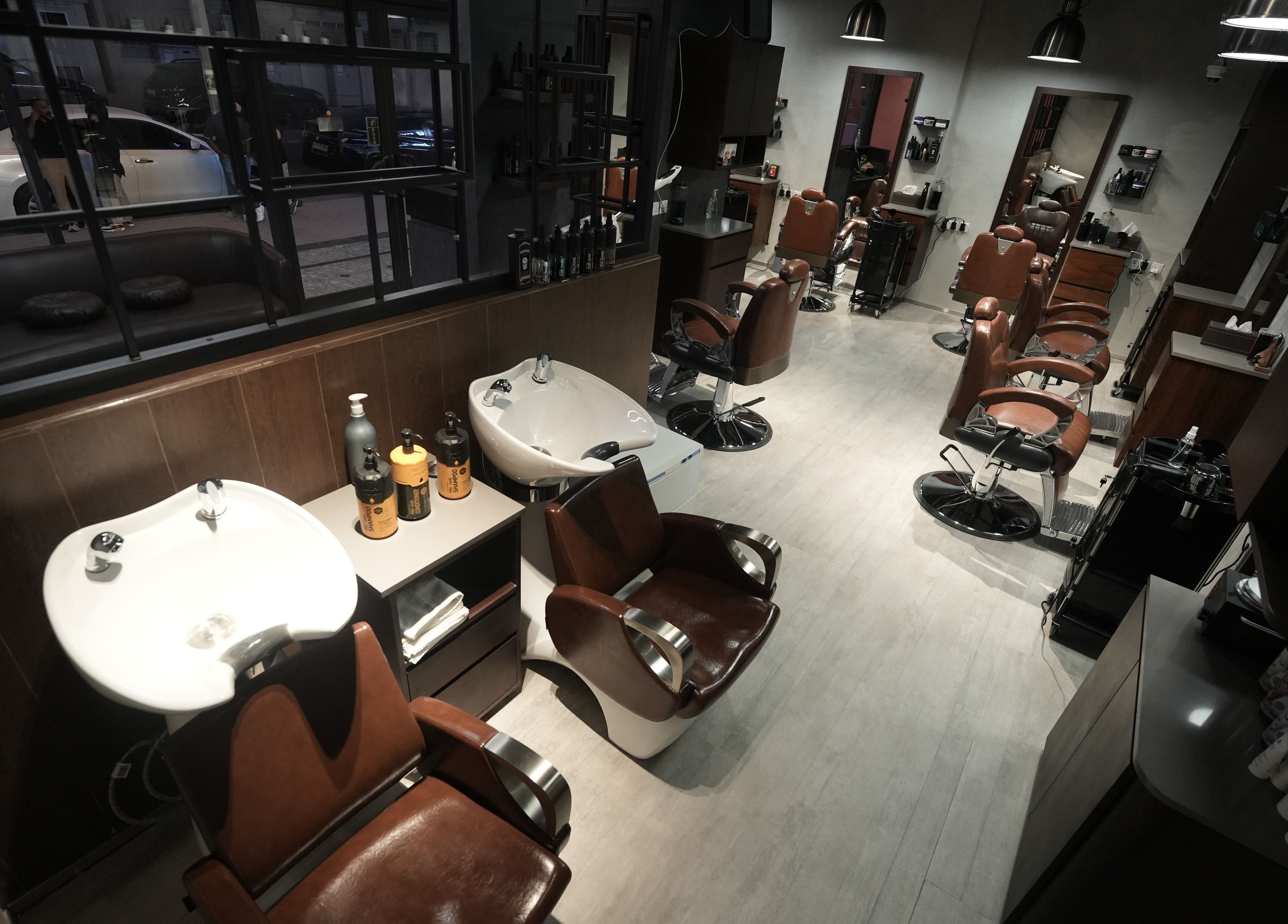 Interior view of Upgrade Barbershop JVC, دبي, دبي, AE showcasing elegant barber chairs and washing stations.
