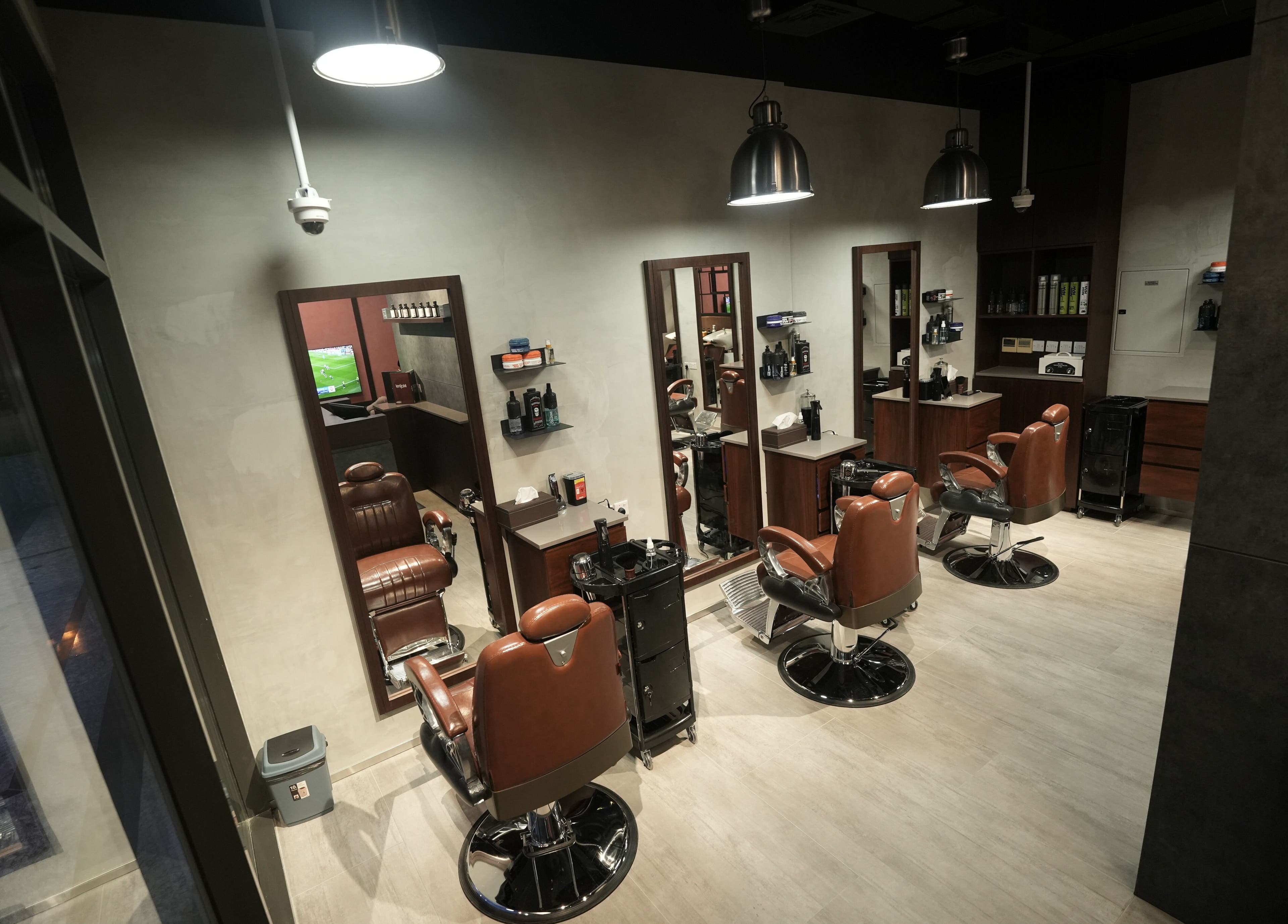 Interior view of Upgrade Barbershop JVC in دبي, دبي, AE, featuring modern barber chairs and styling stations.
