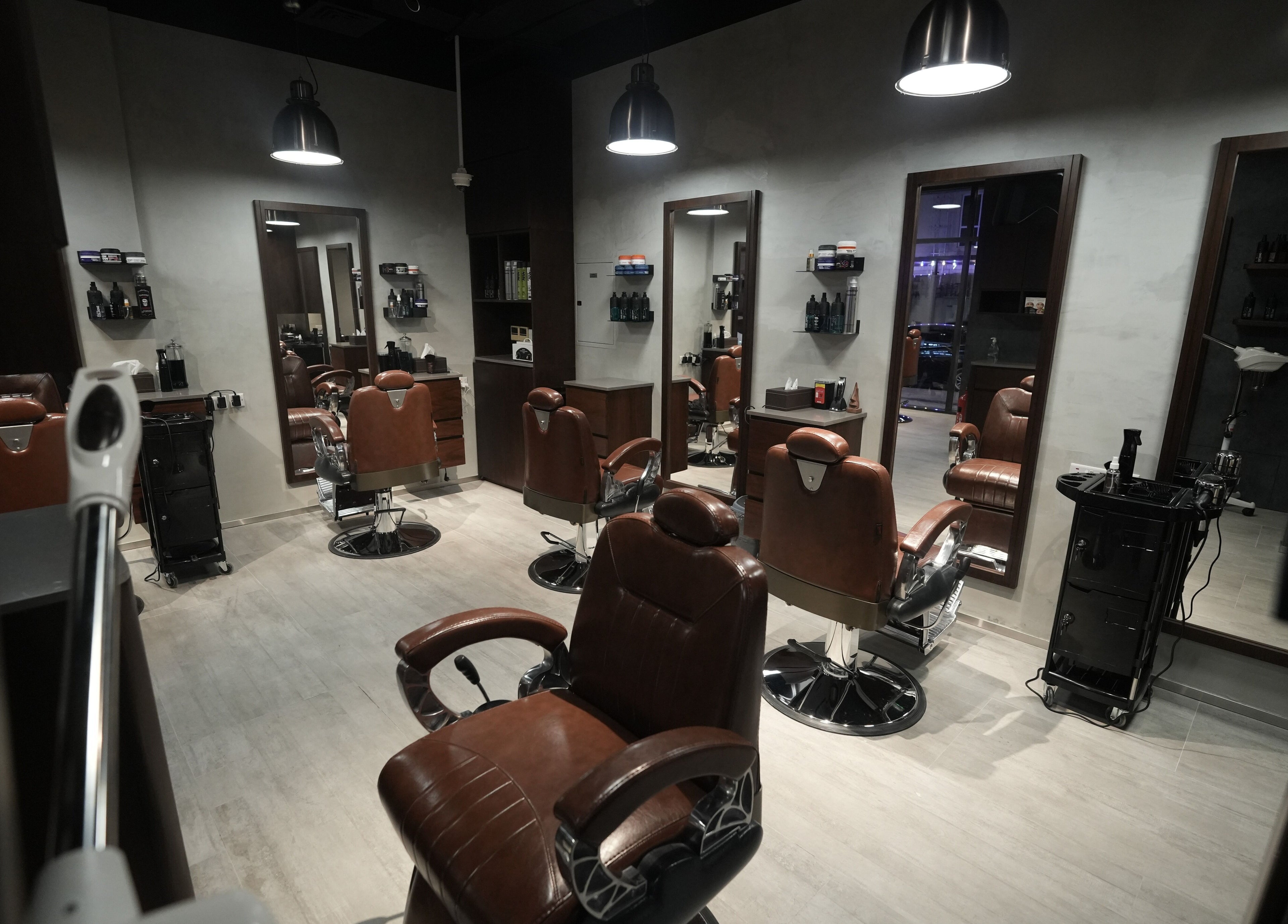 Interior of Upgrade Barbershop JVC featuring sleek brown leather chairs in دبي, دبي, AE.