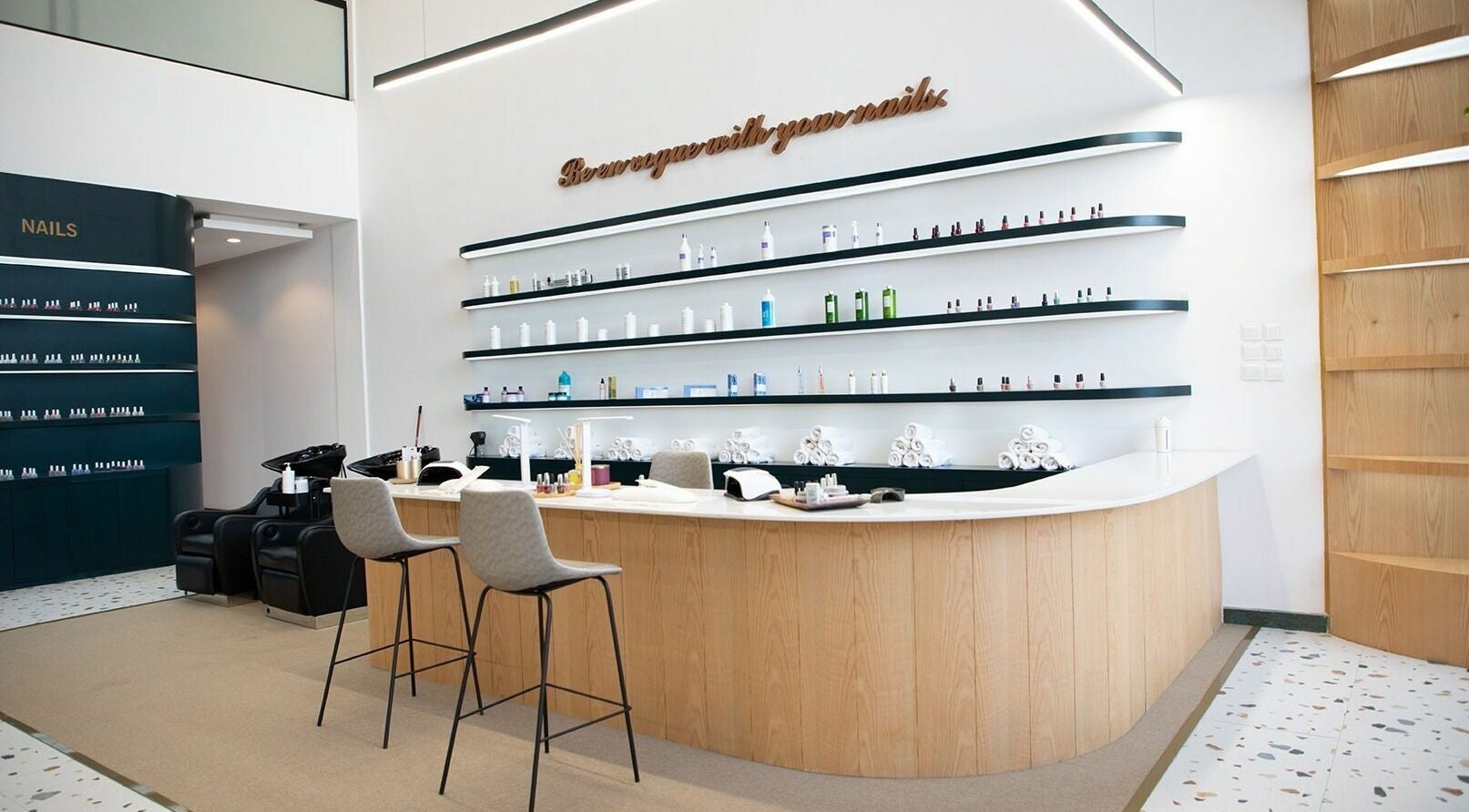 Modern interior of Jeunesse Salon | صالون جونيس in Riyadh, featuring sleek nail stations and stylish decor.