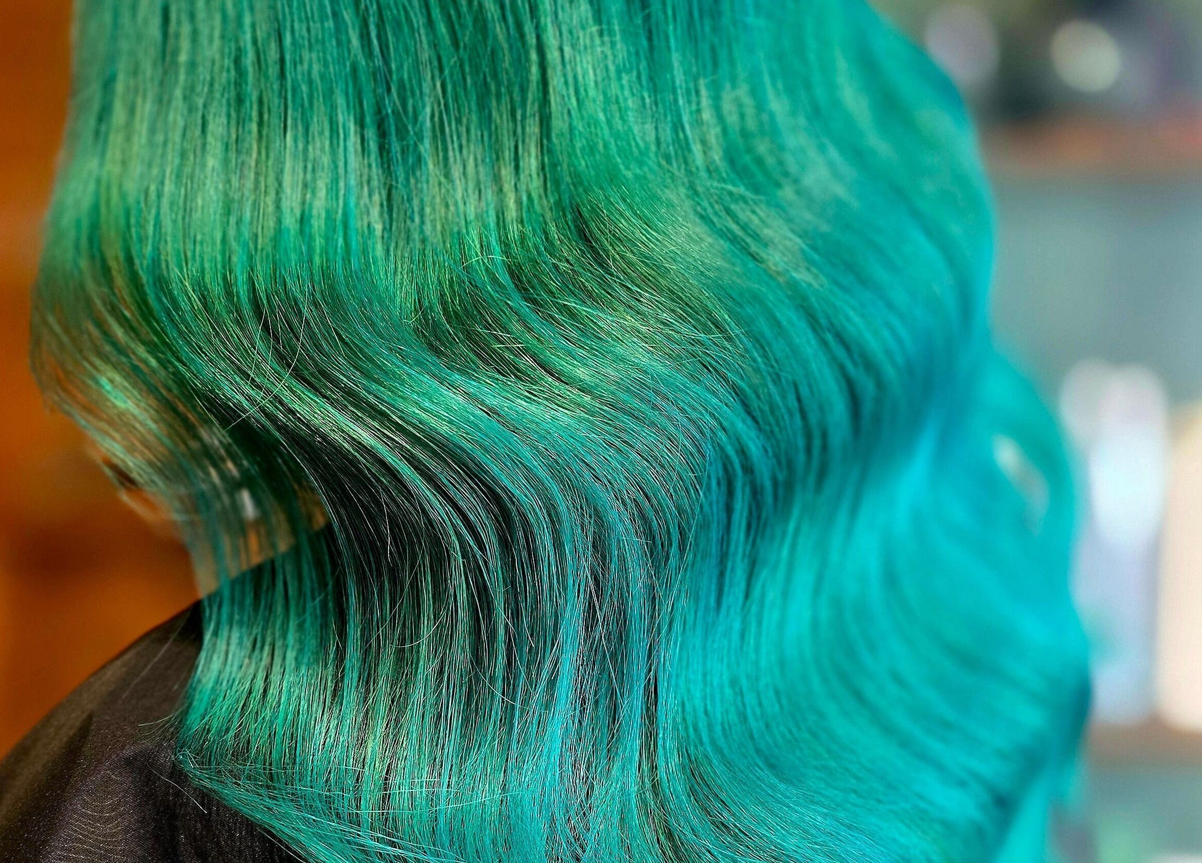 Vibrant emerald green hair styled elegantly at Unique Hair Design in Nelson, Nelson, NZ.