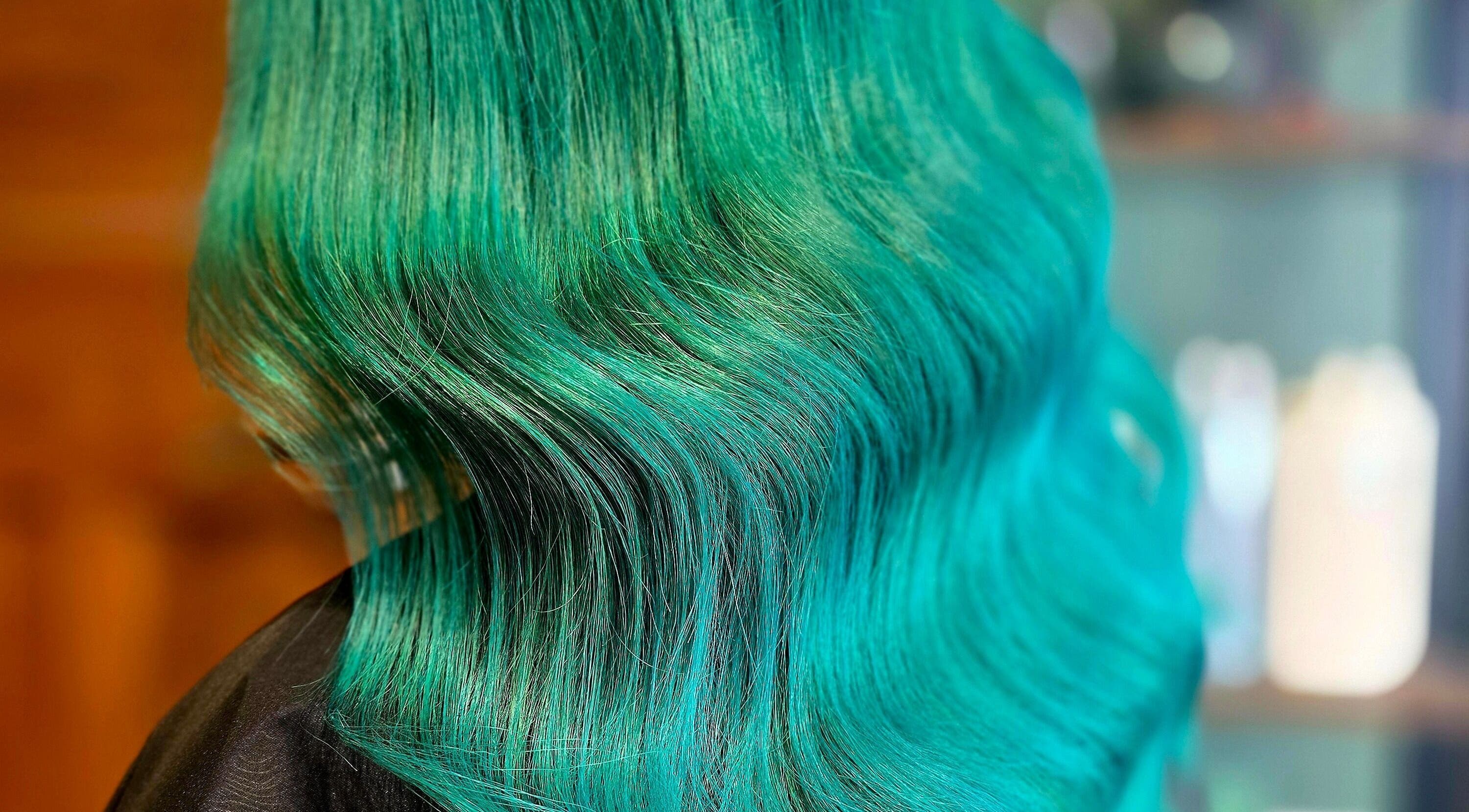 Vibrant emerald green hair styled elegantly at Unique Hair Design in Nelson, Nelson, NZ.