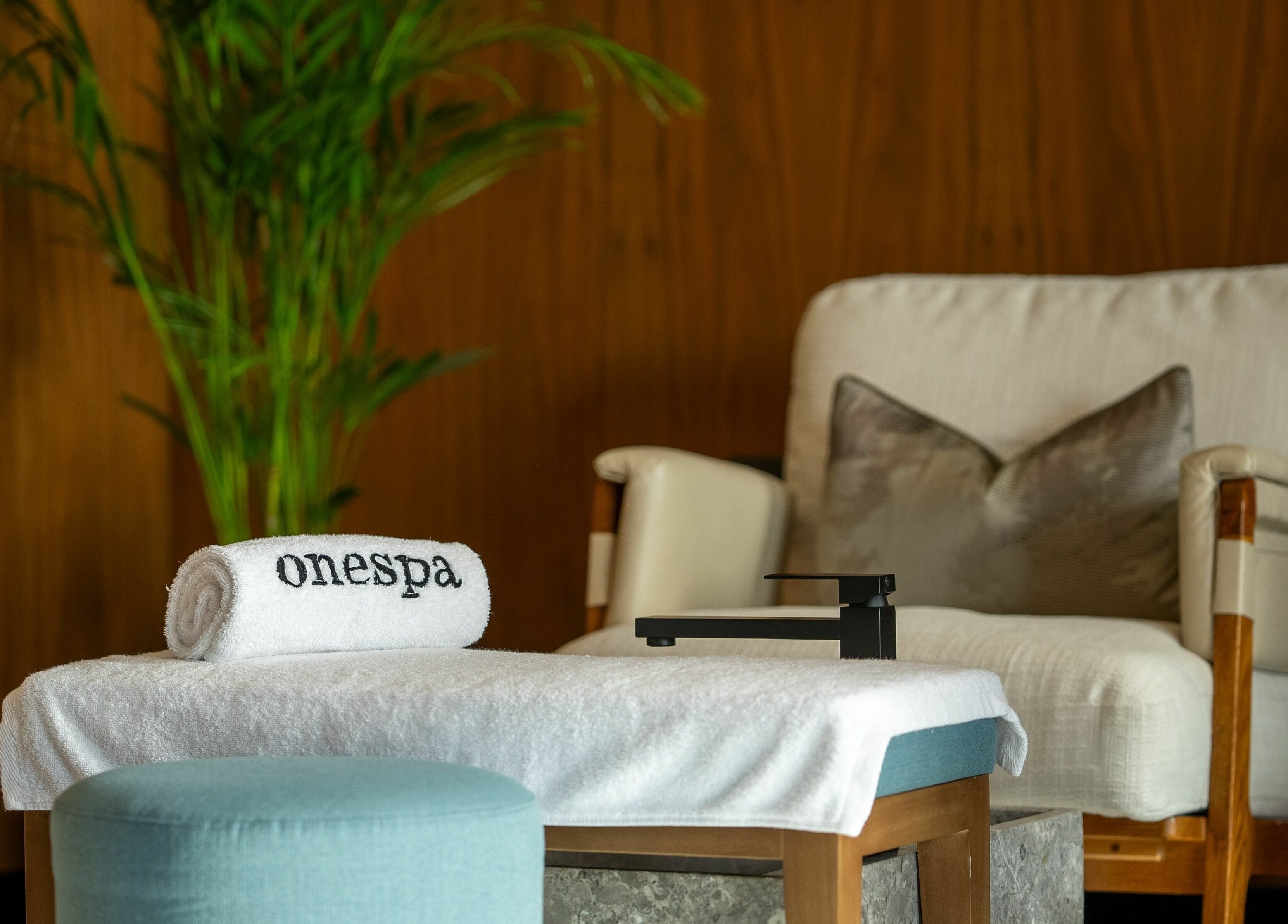 Relaxing lounge at One Spa, Riyadh, Riyadh Province, SA, with plush chair and towel.