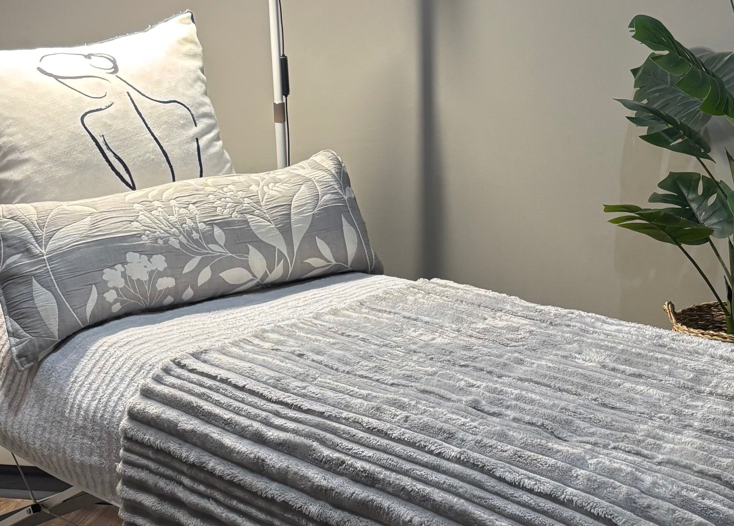 Relaxing bed setup at RosyTouch Aesthetics Ceres, Western Cape, ZA showcasing cozy pillows and calming decor.