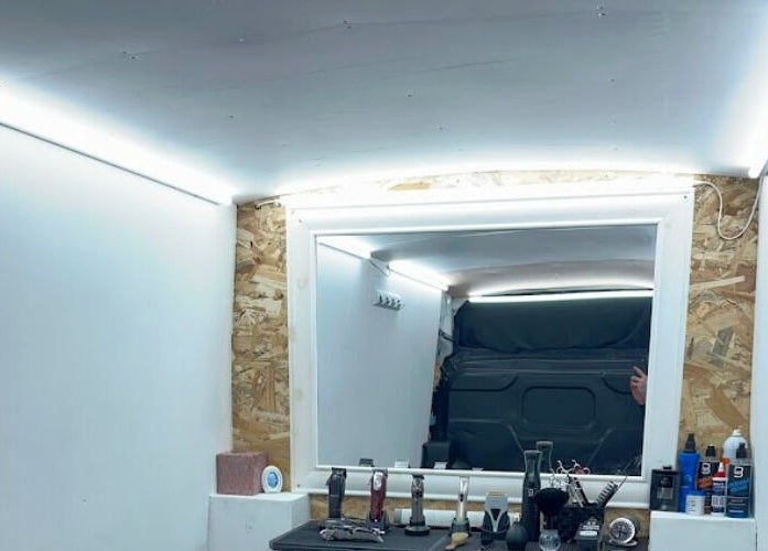 Interior view of Vivid Mobile Barbers in Folkestone, England, GB showing a well-equipped barber station.