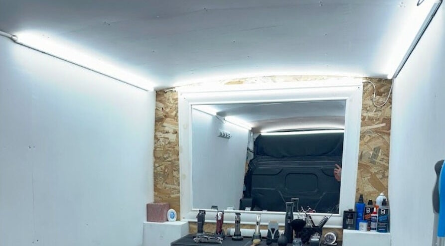 Interior view of Vivid Mobile Barbers in Folkestone, England, GB showing a well-equipped barber station.