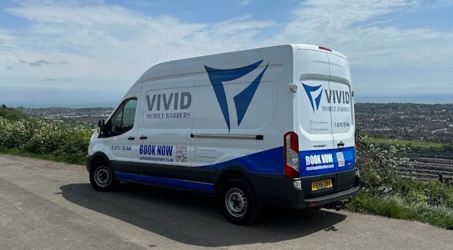 Vivid Mobile Barbers van parked with scenic Folkestone, England, GB view in backdrop.