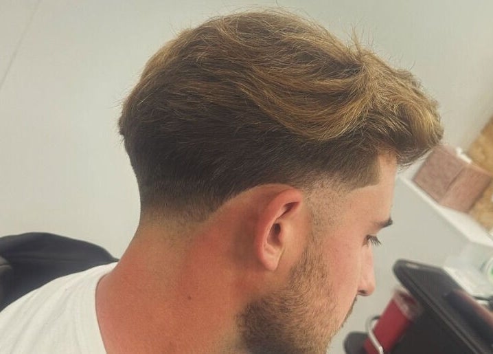 Fresh fade haircut at Vivid Mobile Barbers in Folkestone, England, GB, showcasing modern styling.