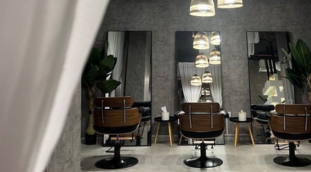 Modern salon interior at Fylla Beauty Lounge, Al Ain, Abu Dhabi, AE, featuring sleek chairs and mirrors.