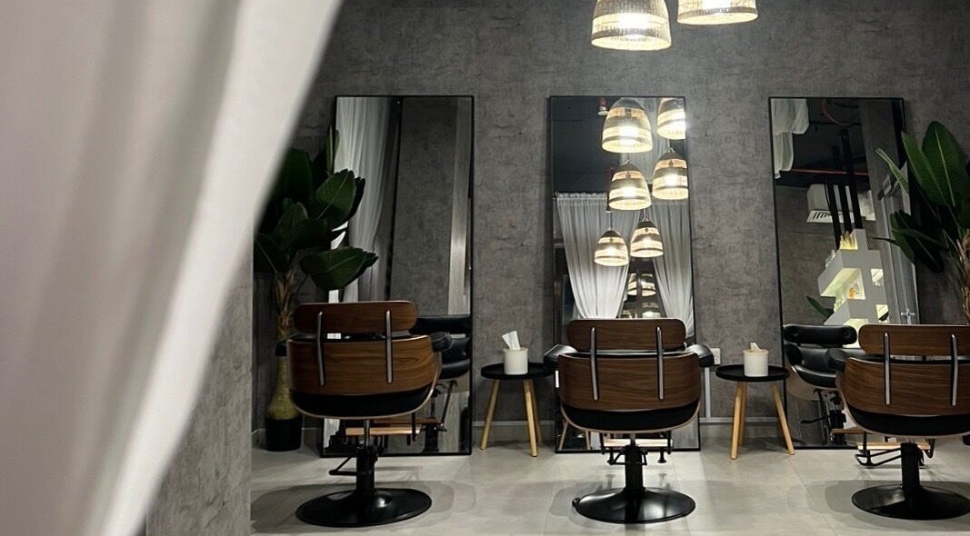 Elegant salon chairs and mirrors at Fylla Beauty Lounge, Al Ain, Abu Dhabi, AE, showcasing a modern styling area.
