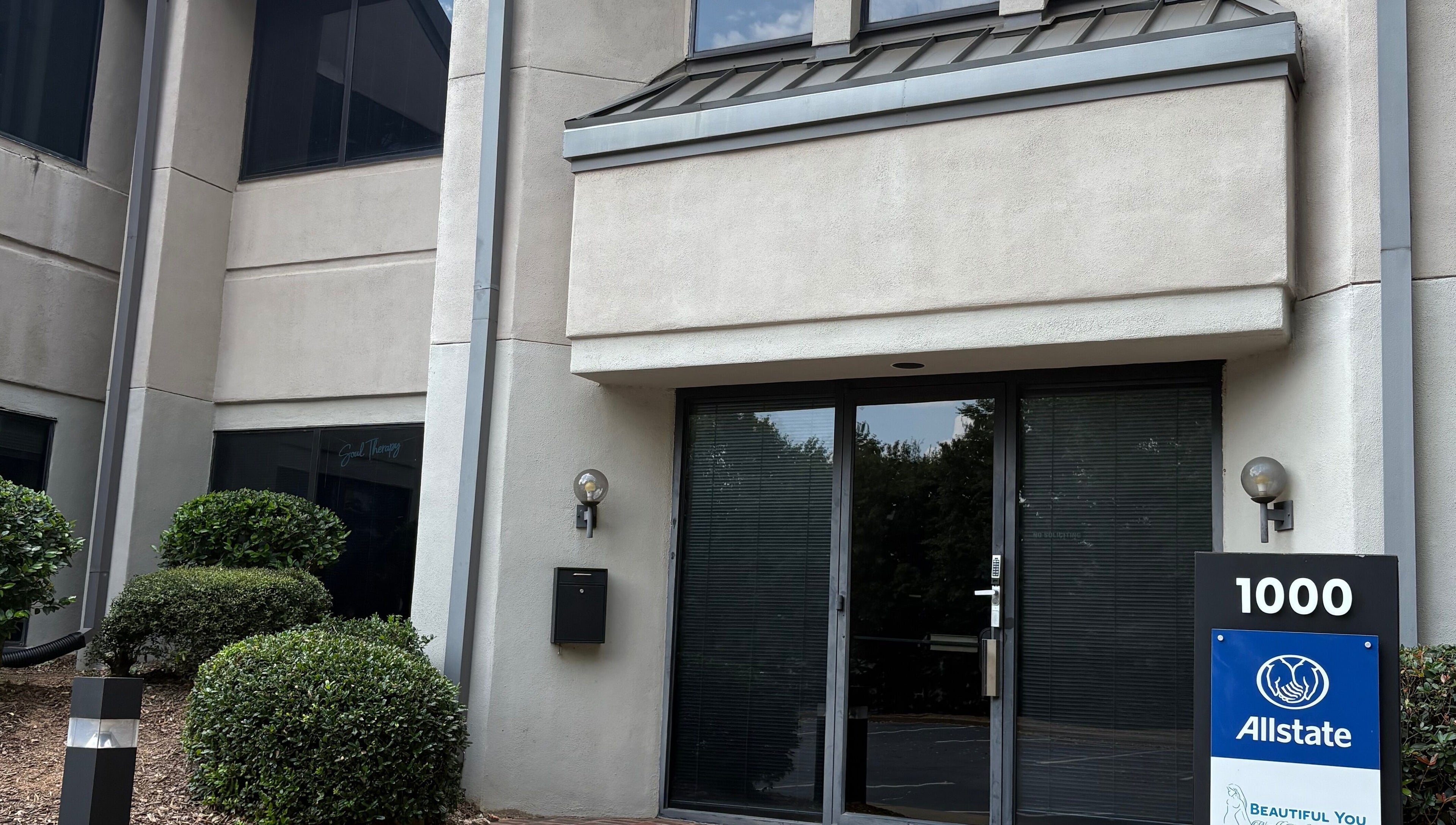 Entrance of Tiffani Blu Studios in Atlanta, Georgia, US with modern facade and greenery.