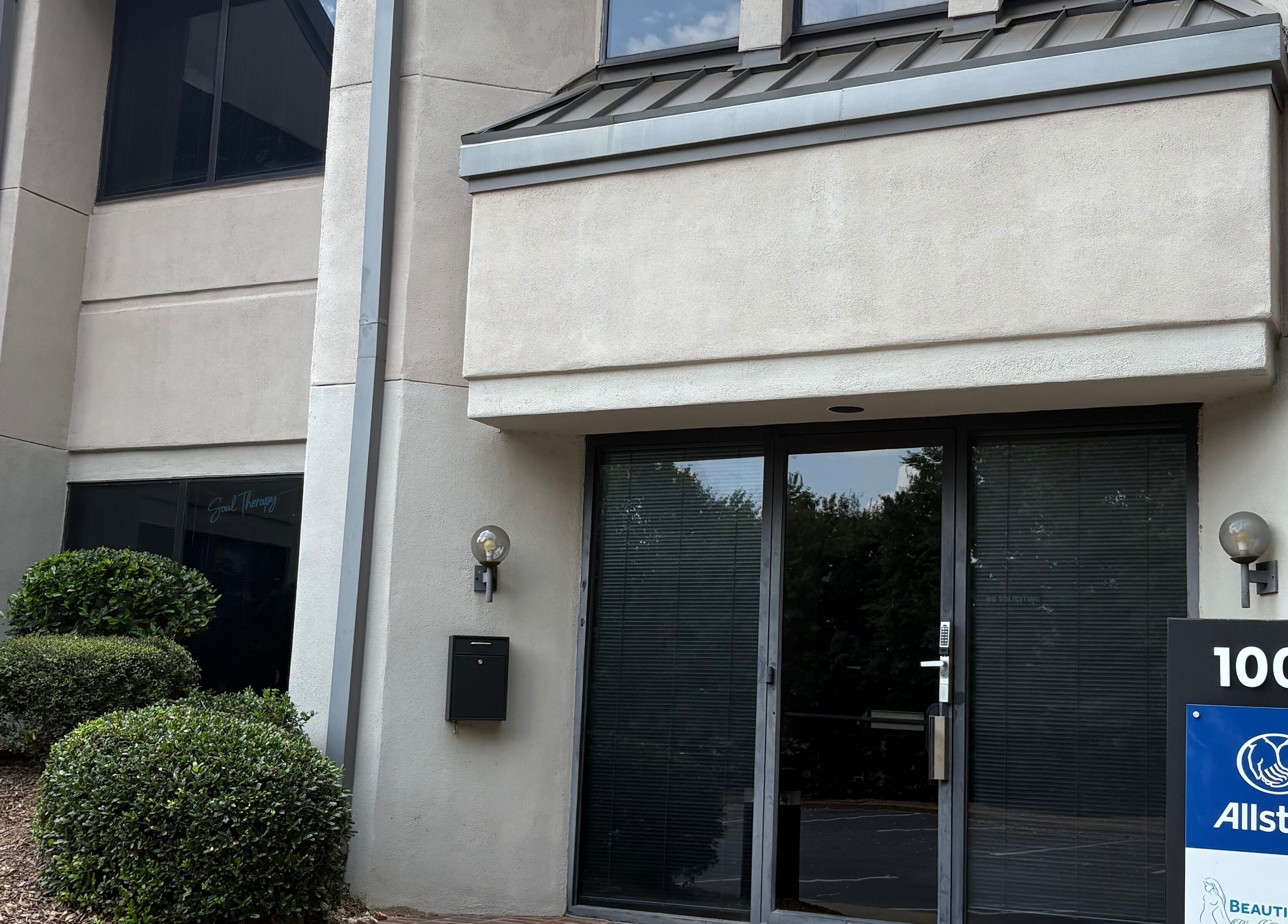 Entrance of Tiffani Blu Studios in Atlanta, Georgia, US with modern facade and greenery.