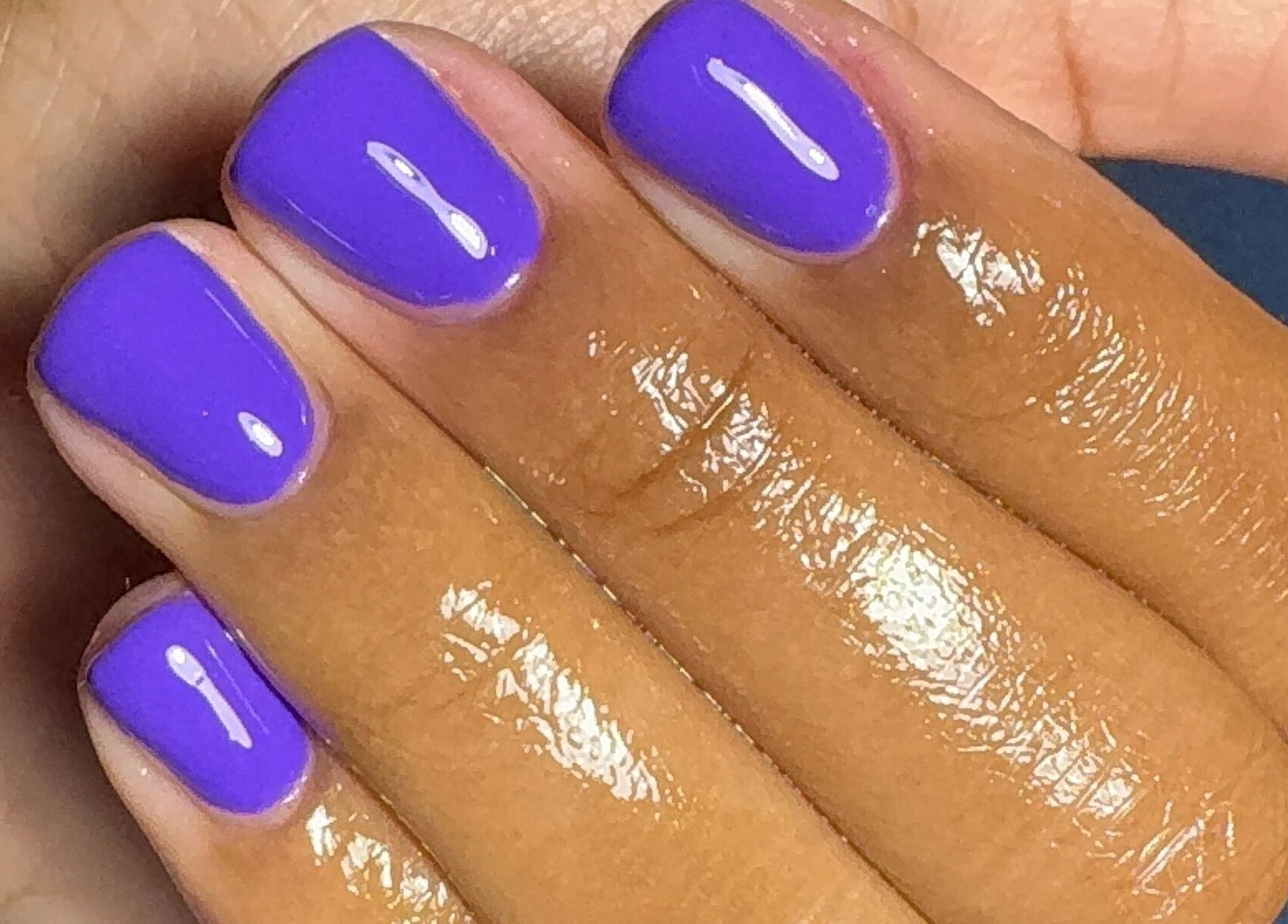 Bright violet nails manicure at Tiffani Blu Studios, Atlanta, Georgia, US, showcasing glossy finish.