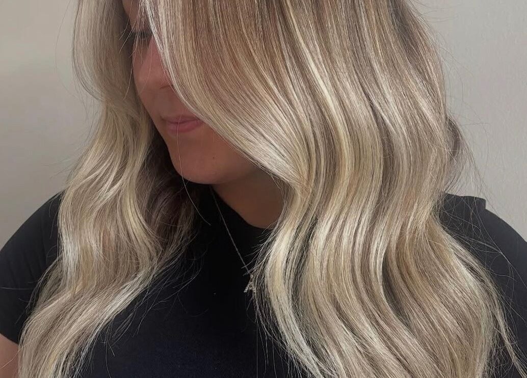 Highlighted wavy hair styled at Taylor Atlanta Hair, Glasgow, Scotland, GB, showcasing a soft, natural look.