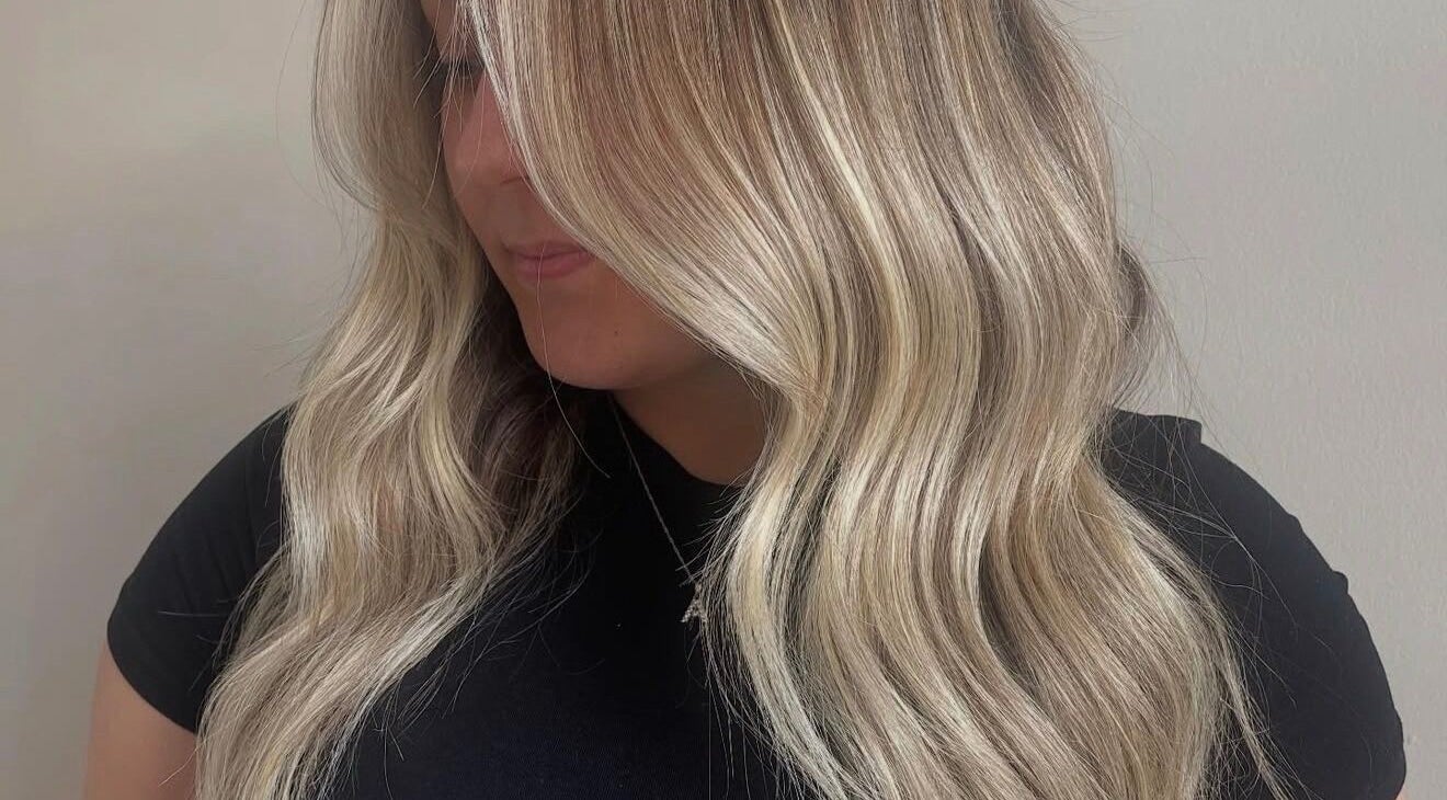 Highlighted wavy hair styled at Taylor Atlanta Hair, Glasgow, Scotland, GB, showcasing a soft, natural look.