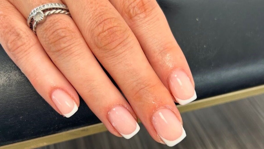 Close-up of a French manicure at Betts Beauty, Farington, England, GB showcasing detailed nail art.