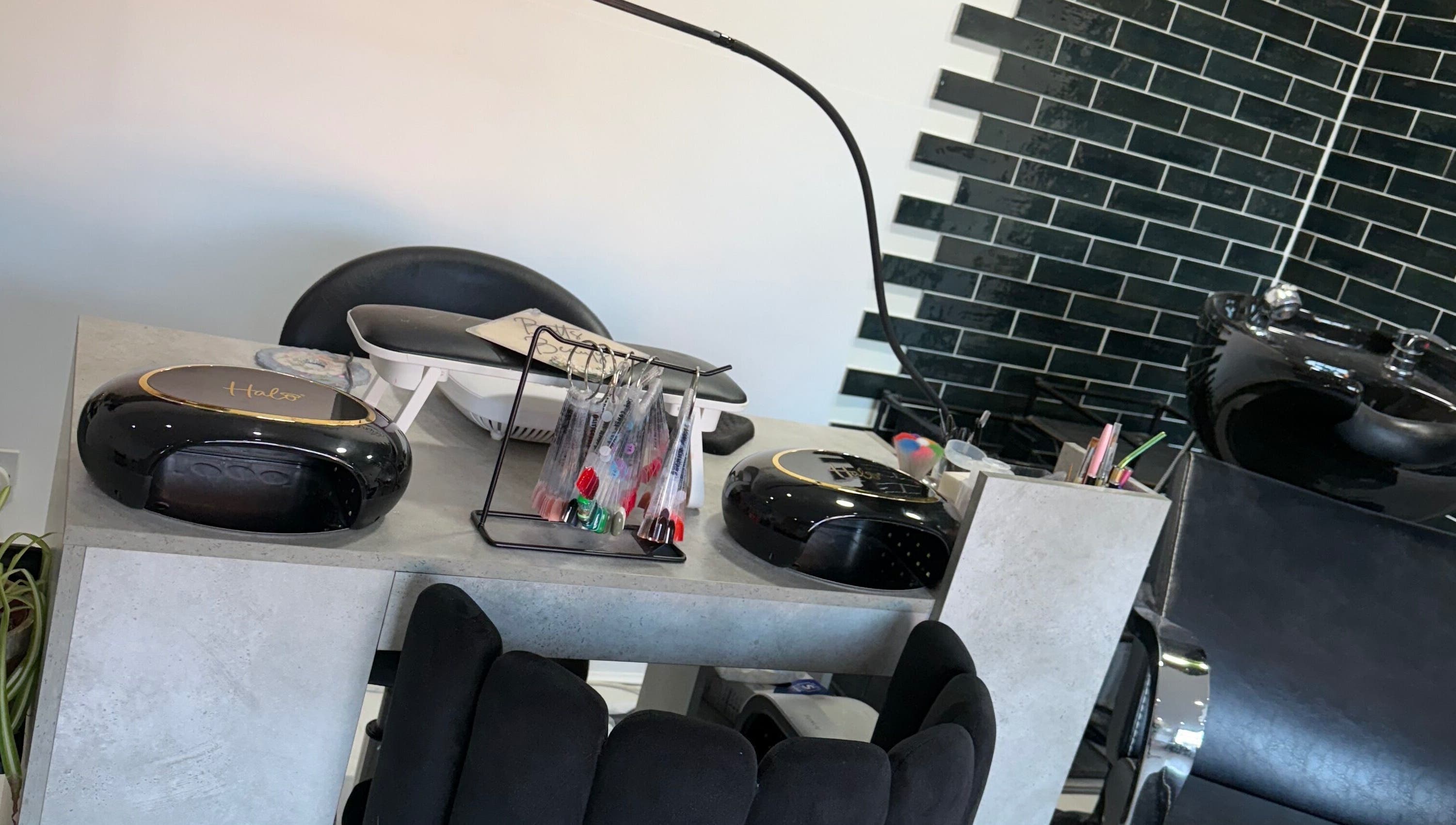 Modern nail and hair station at Betts Beauty, Farington, England, GB showcasing sleek equipment and vibrant décor.