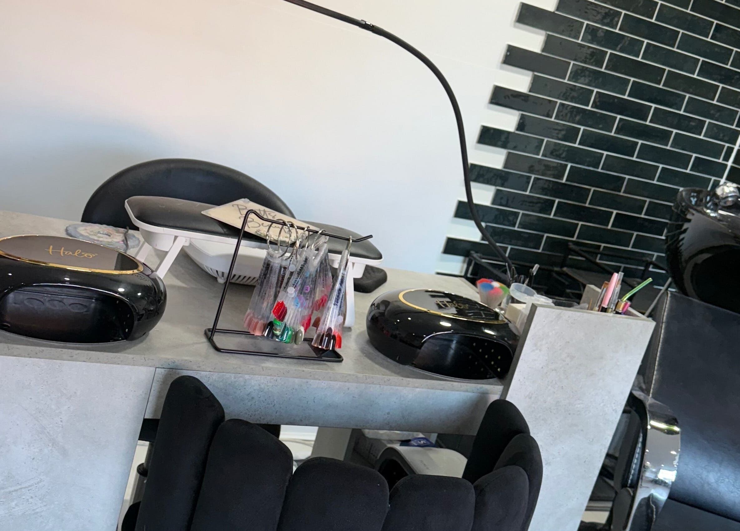 Modern nail and hair station at Betts Beauty, Farington, England, GB showcasing sleek equipment and vibrant décor.