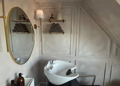 Chic hair washing station at House of RC Hair, Garforth, England, GB, featuring a stylish mirror and shelving.