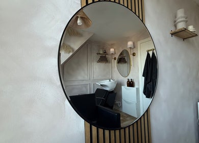 Interior mirror view of Hairology By Rosie salon in Garforth, England showcasing a stylish wash station.